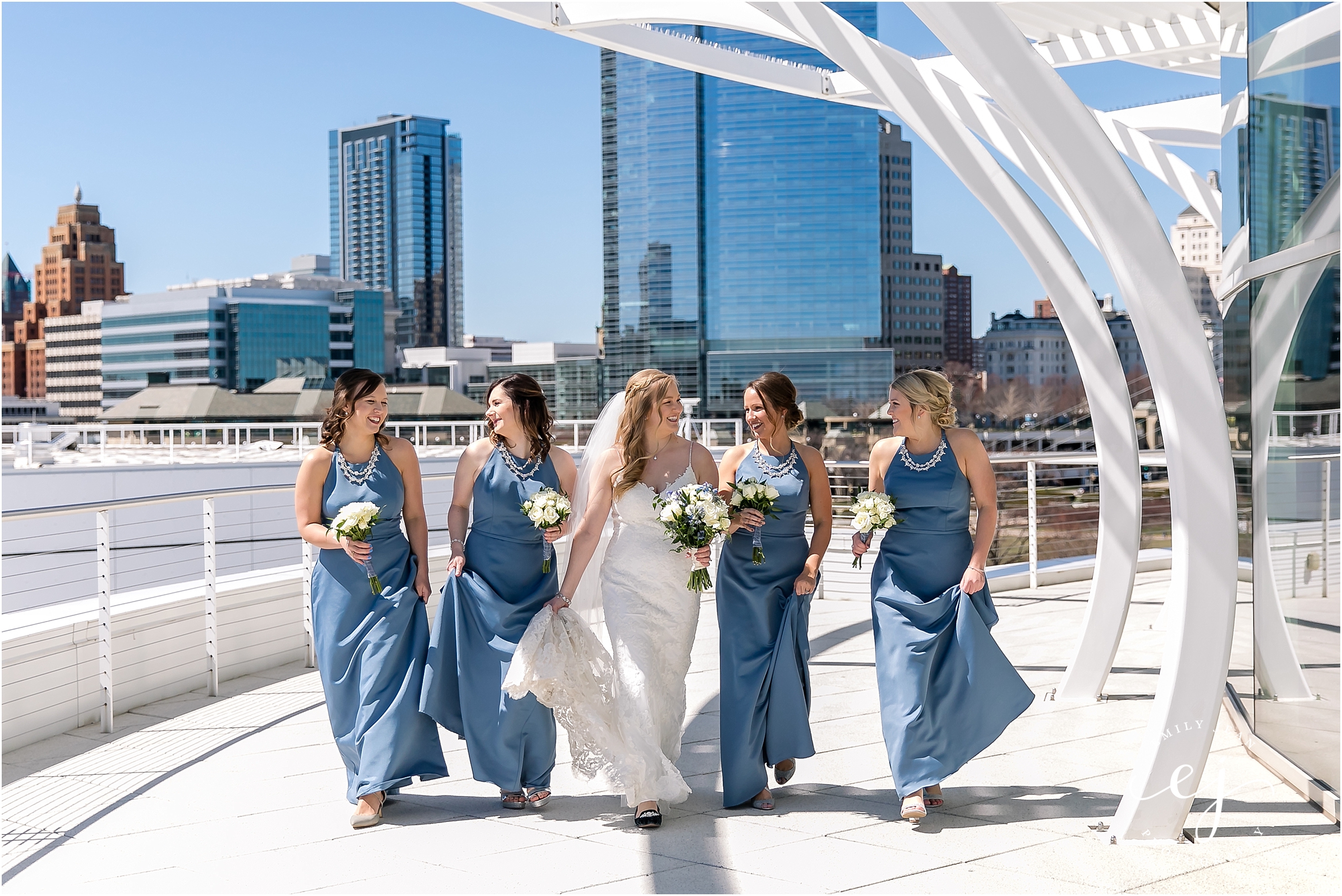 bridesmaids in blue dresses walking pilot house milwaukee wi