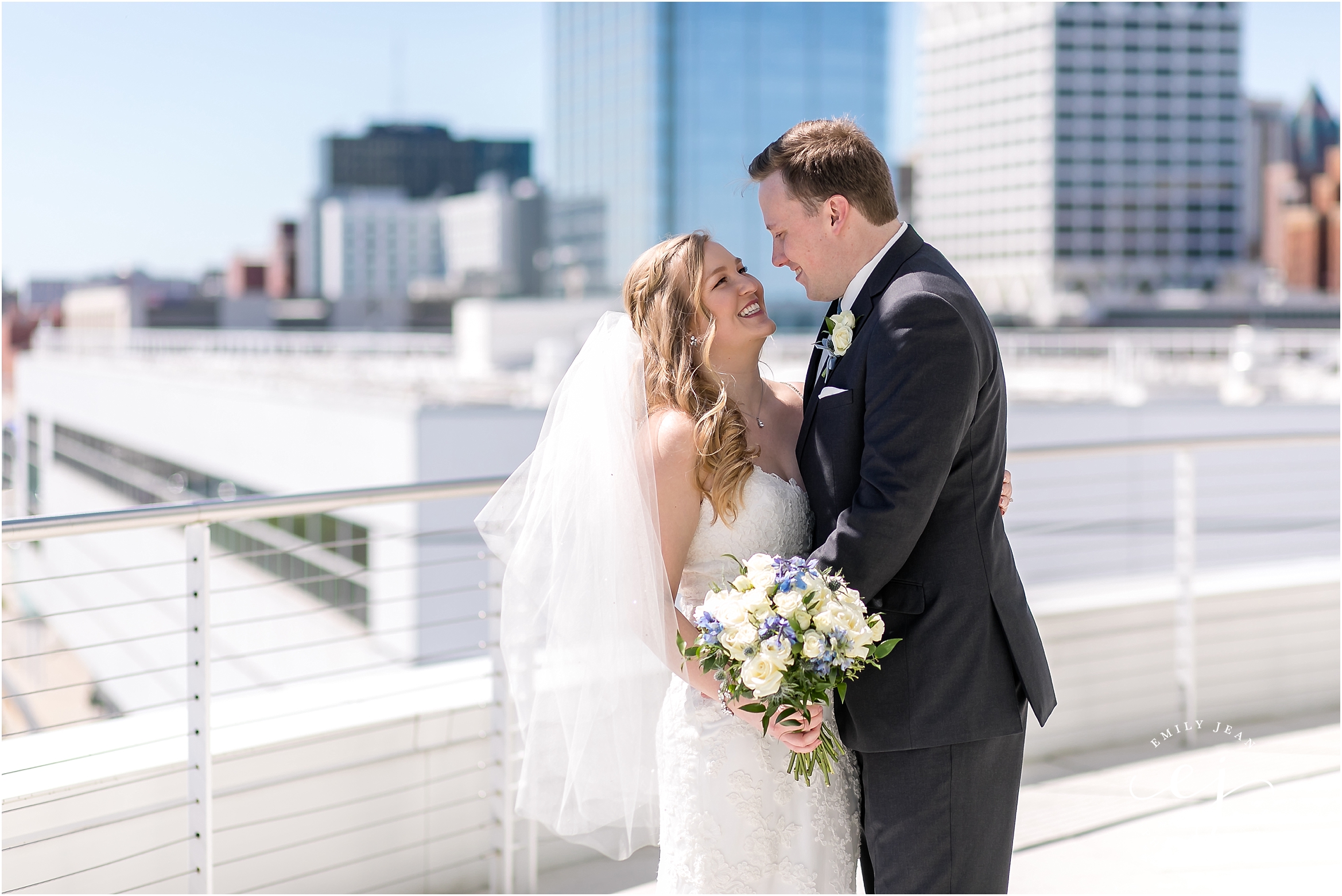 portrait of bride and groom with milwaukee city in background
