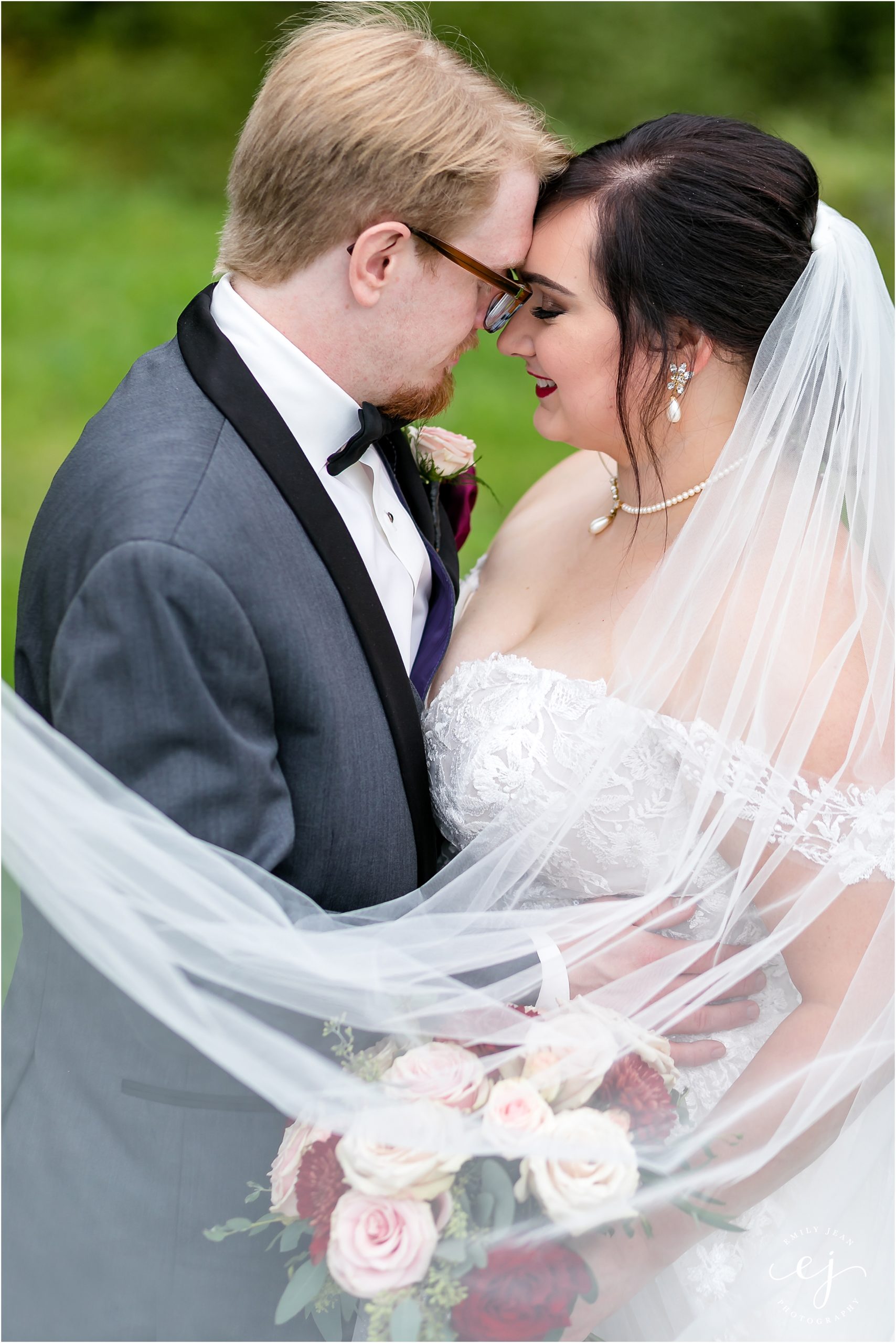 bride and groom at caledonia winnebago springs wedding grey tux and lace wedding dress with long lace veil