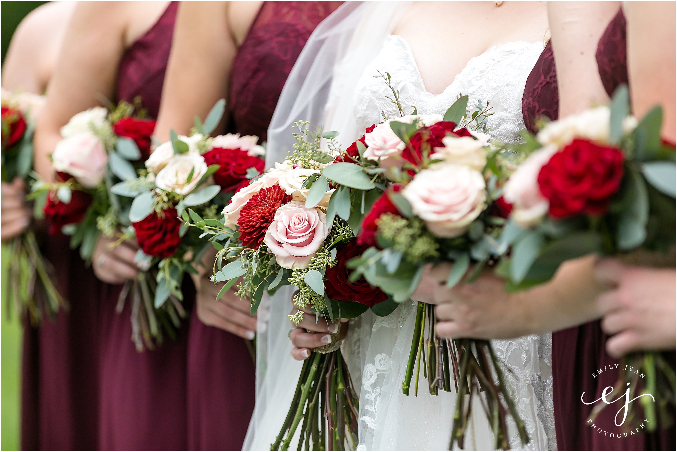 red wine bridesmaid dresses with pink and red bouquets at winnebago springs wedding venue minnesota
