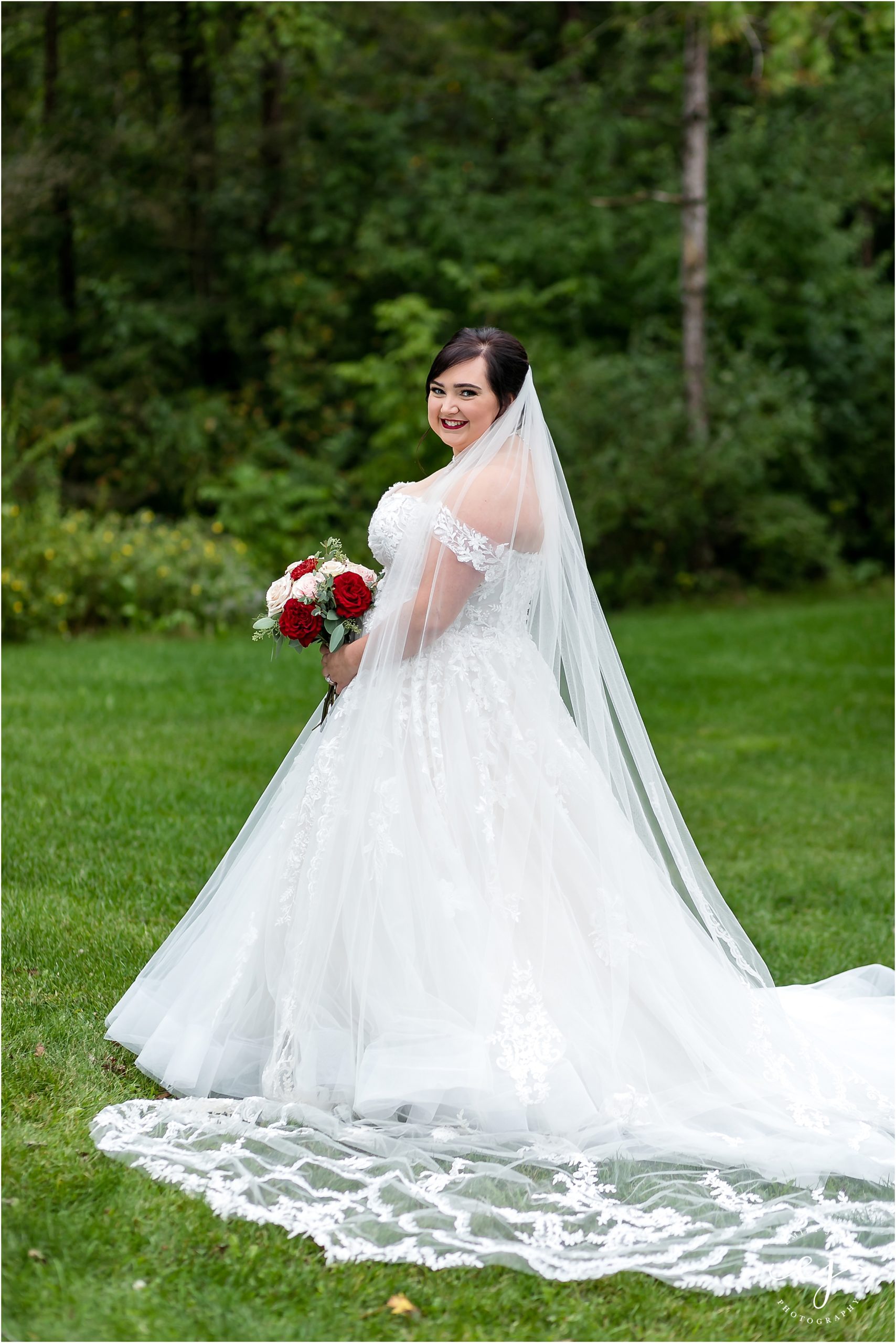 bride in large ball gown with lace veil wedding dress at winnebago springs wedding caledonia minnesota