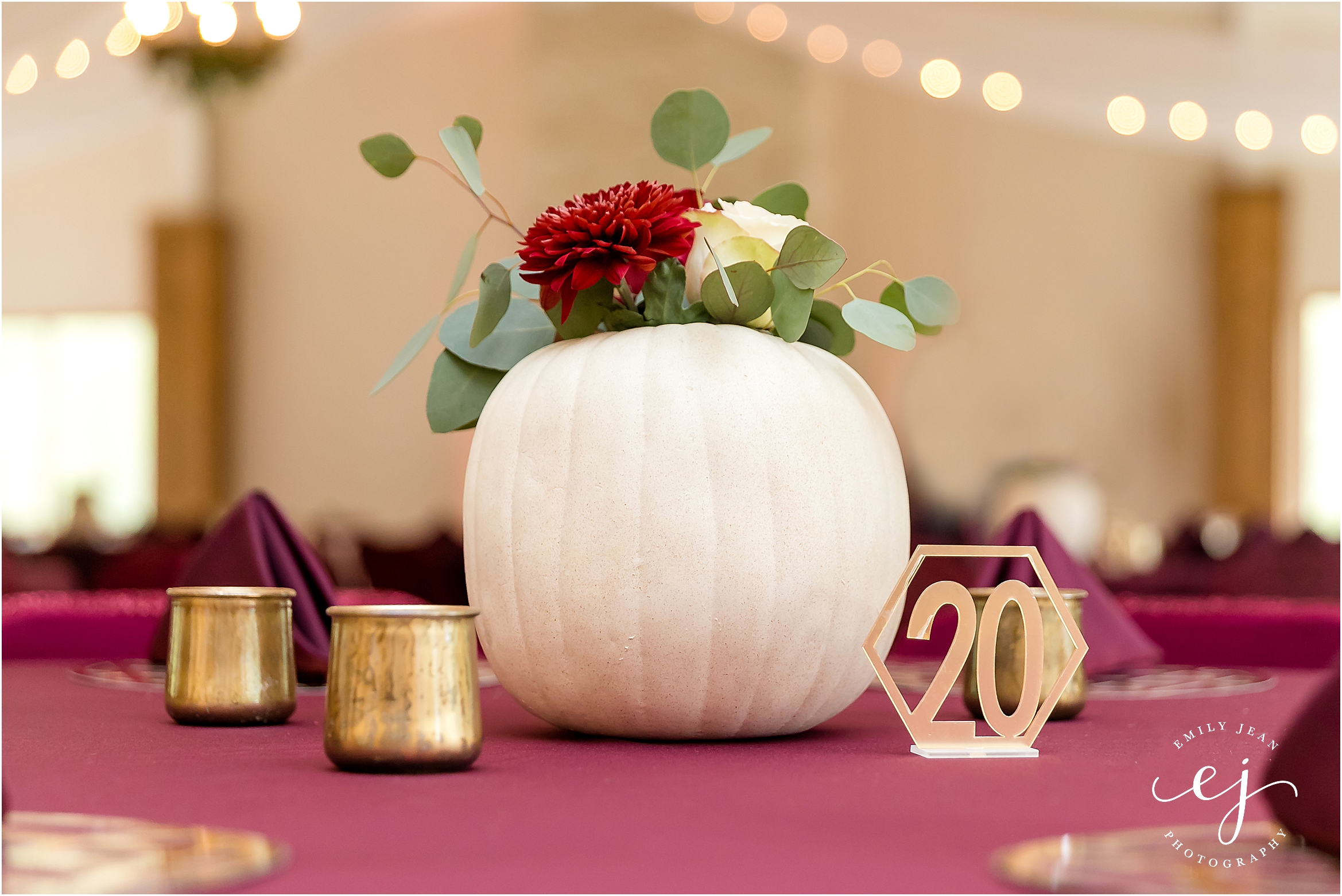 white pumpkin with floral inside center piece gold geometic table number with twinkle lights