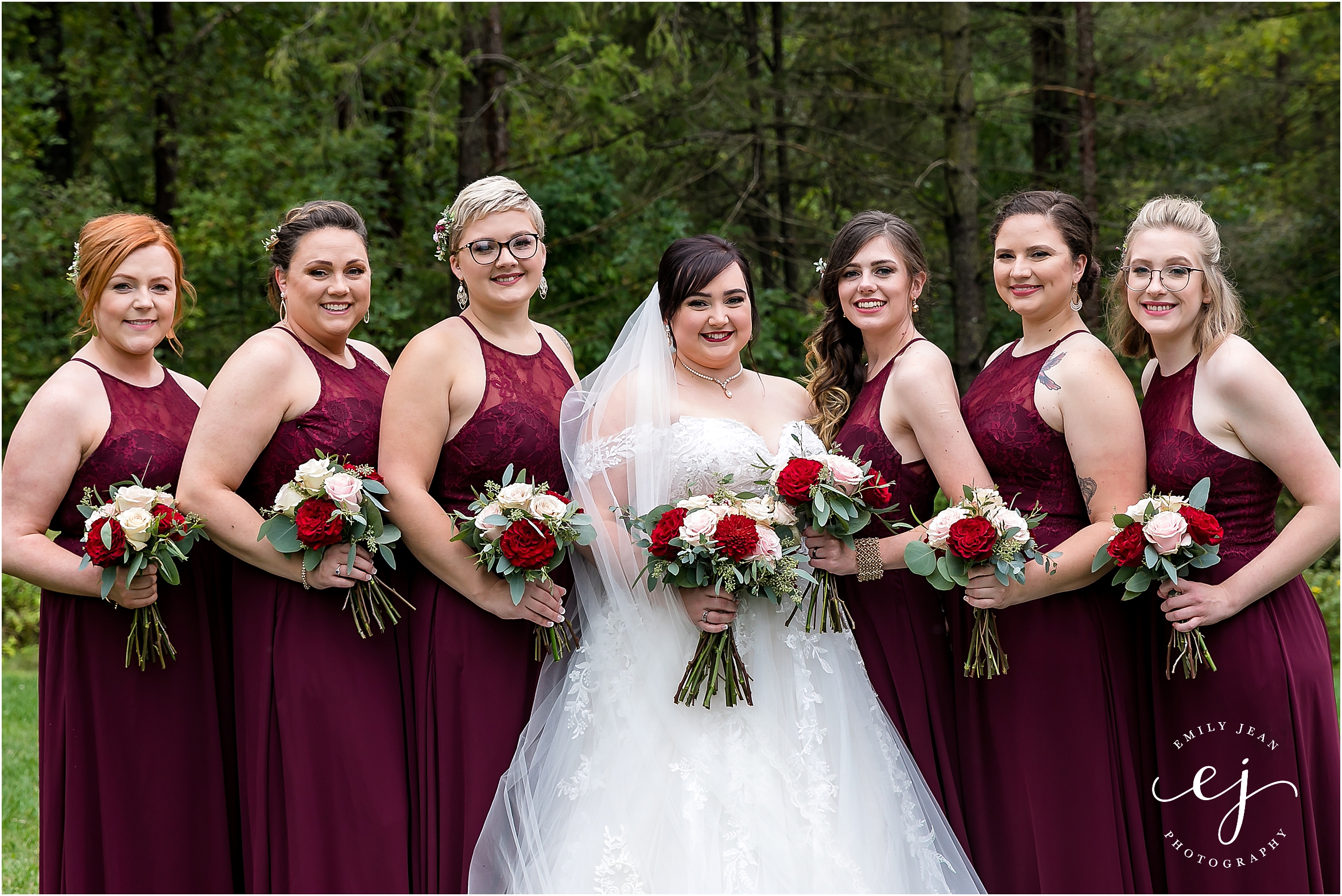 red wine bridesmaid dresses with pink and red bouquets at winnebago springs wedding venue minnesota