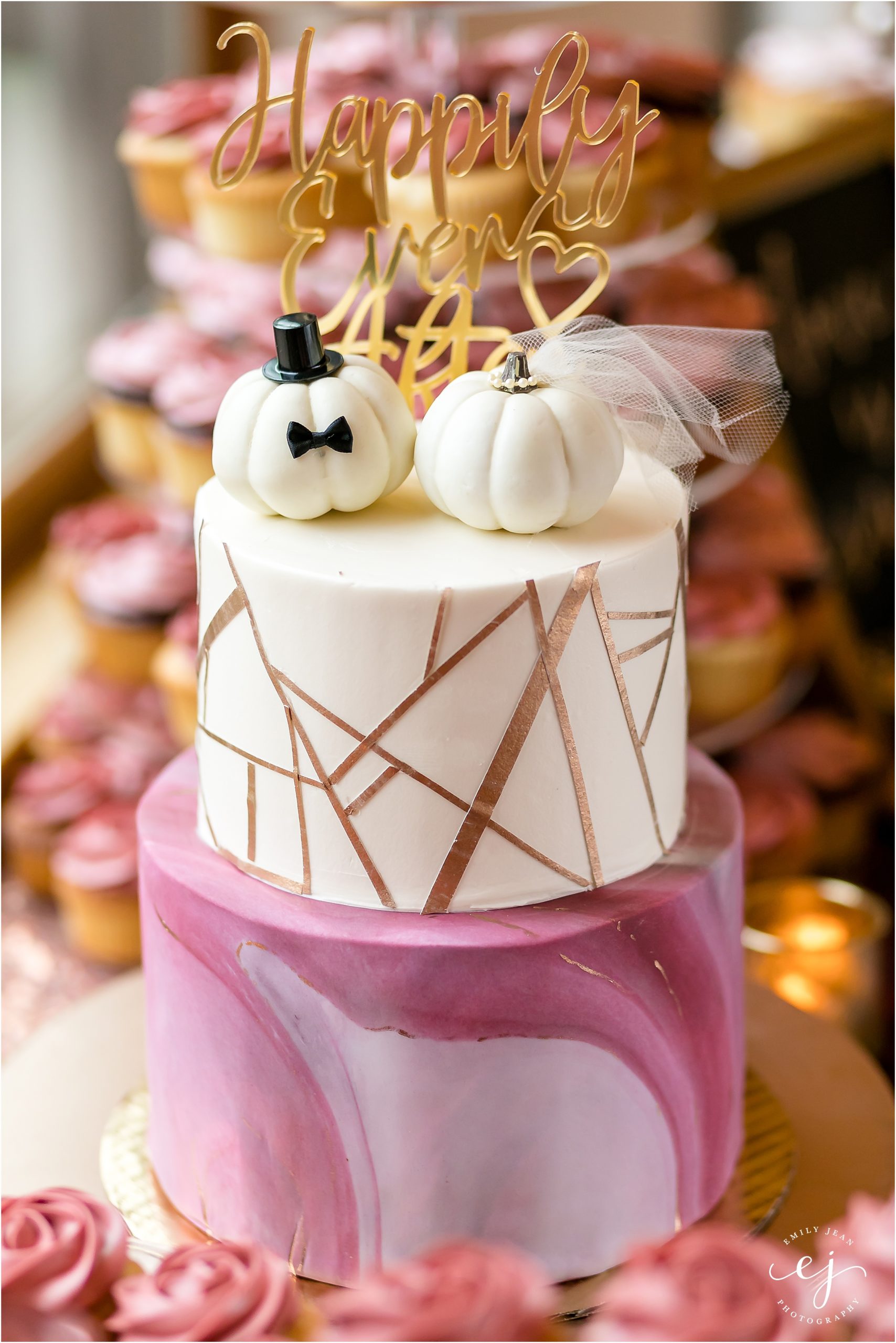 pink and white and gold geometric wedding cake with white pumpkin cake topper