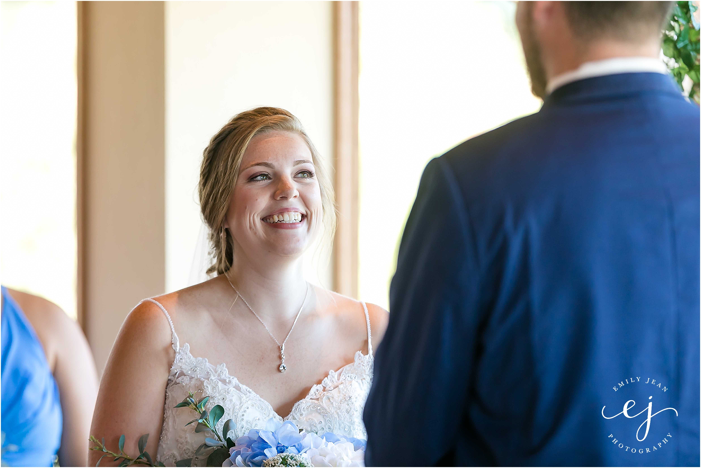 bride smiling at groom during ceremony cedar creek onalaska wisconsin