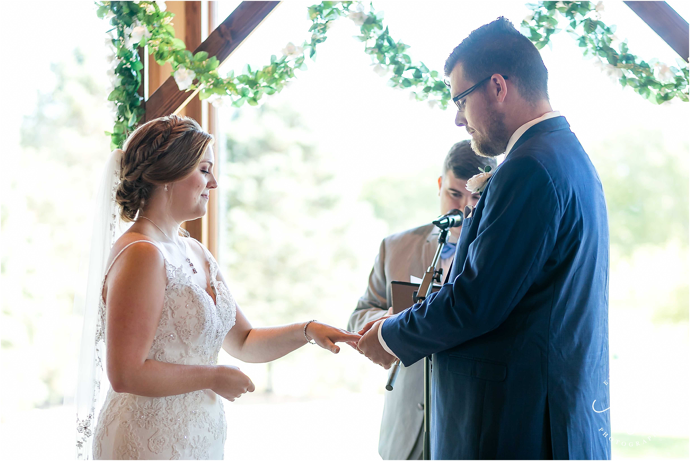 exchanging rings in front of window at cedar creek country 