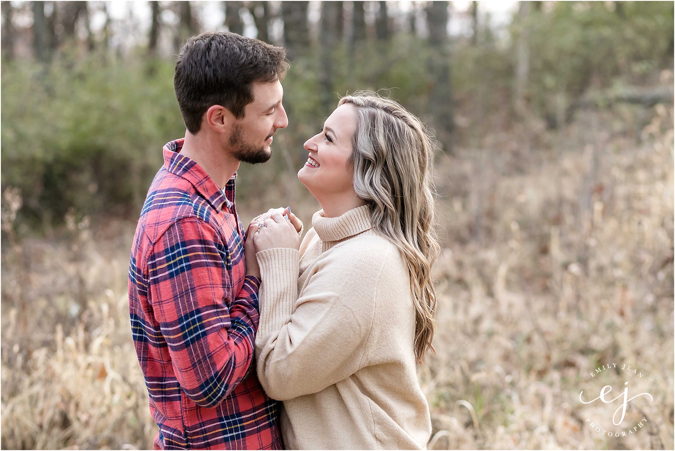 la crosse grandad bluff engagement session dancing in field with wild grass flannel and jeans