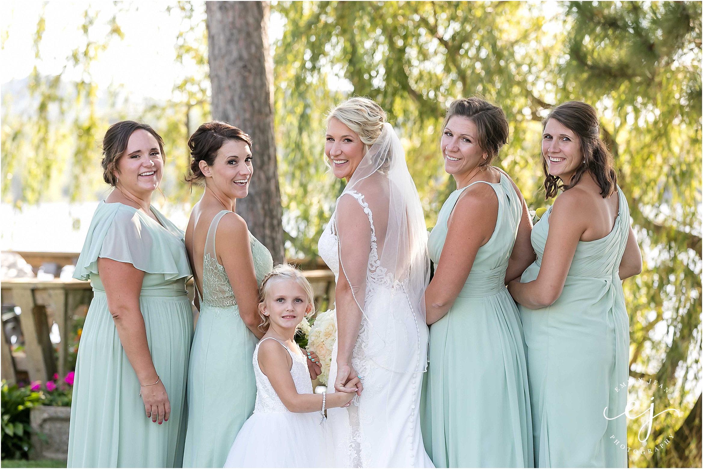 bridesmaids in green dresses with white flowers la crosse wisconsin wedding