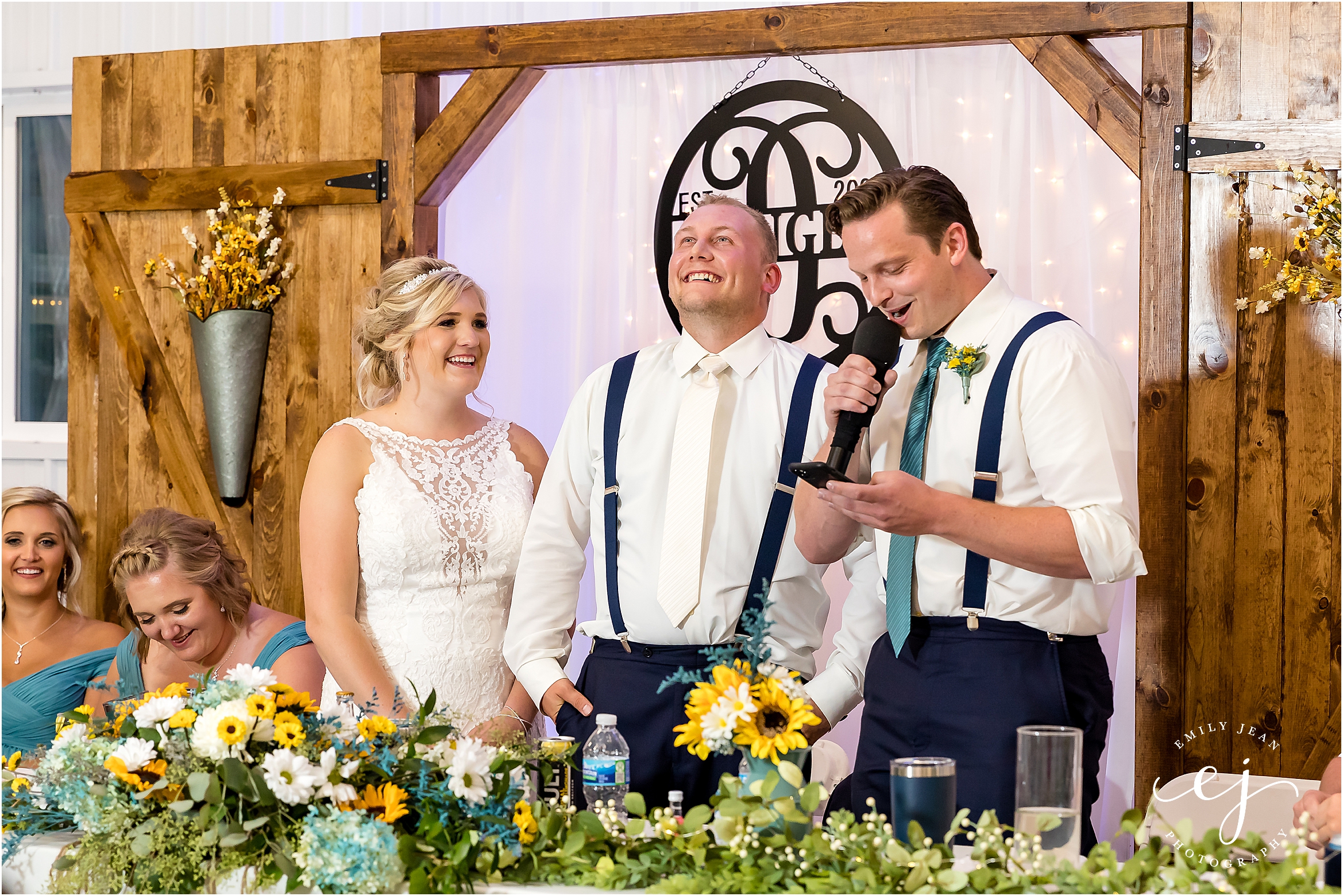 best man speech with white twinkle light backdrop at head table
