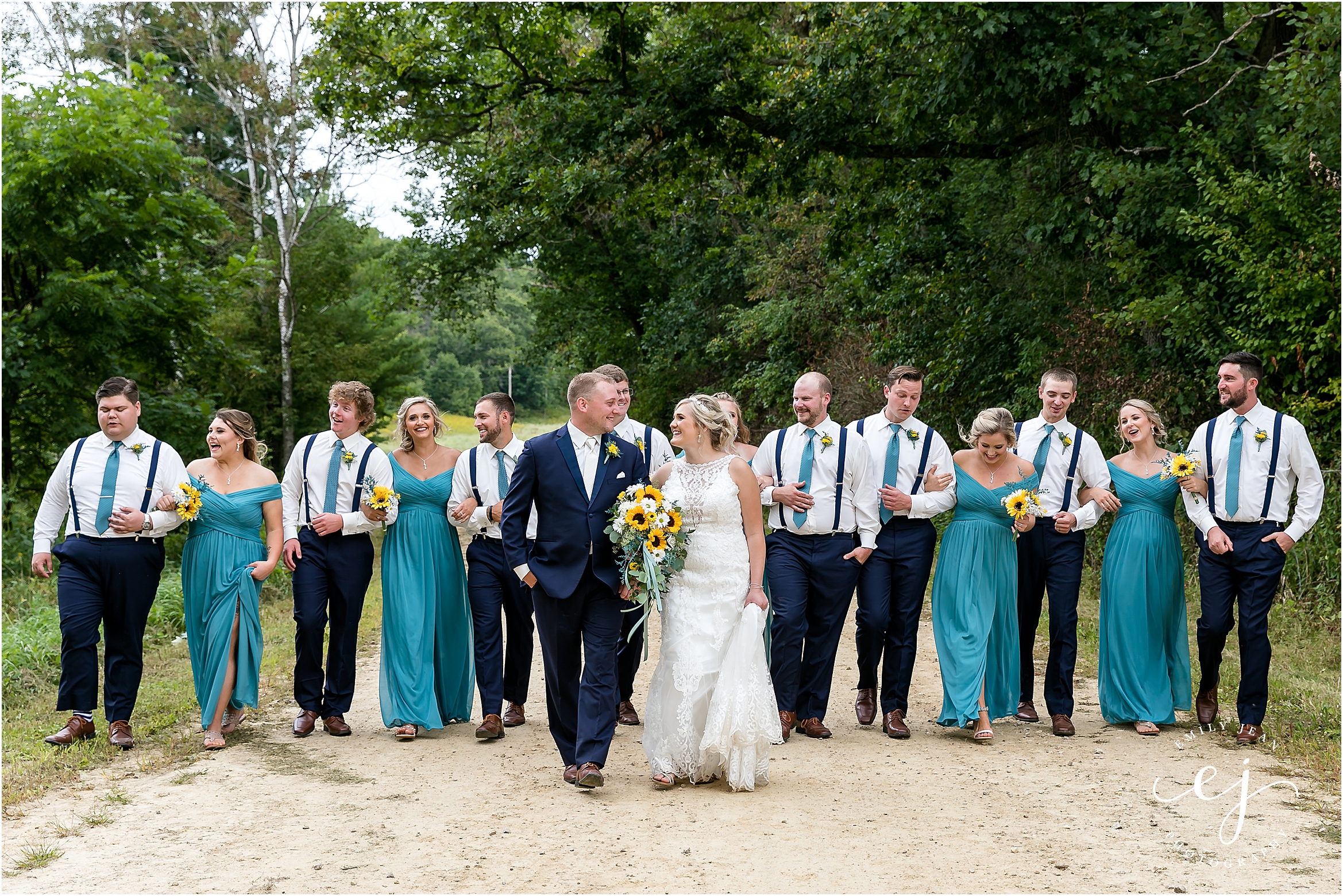 groomsmen in suspenders walking and laughing blair wisconsin wedding bridesmaids in teal dresses
