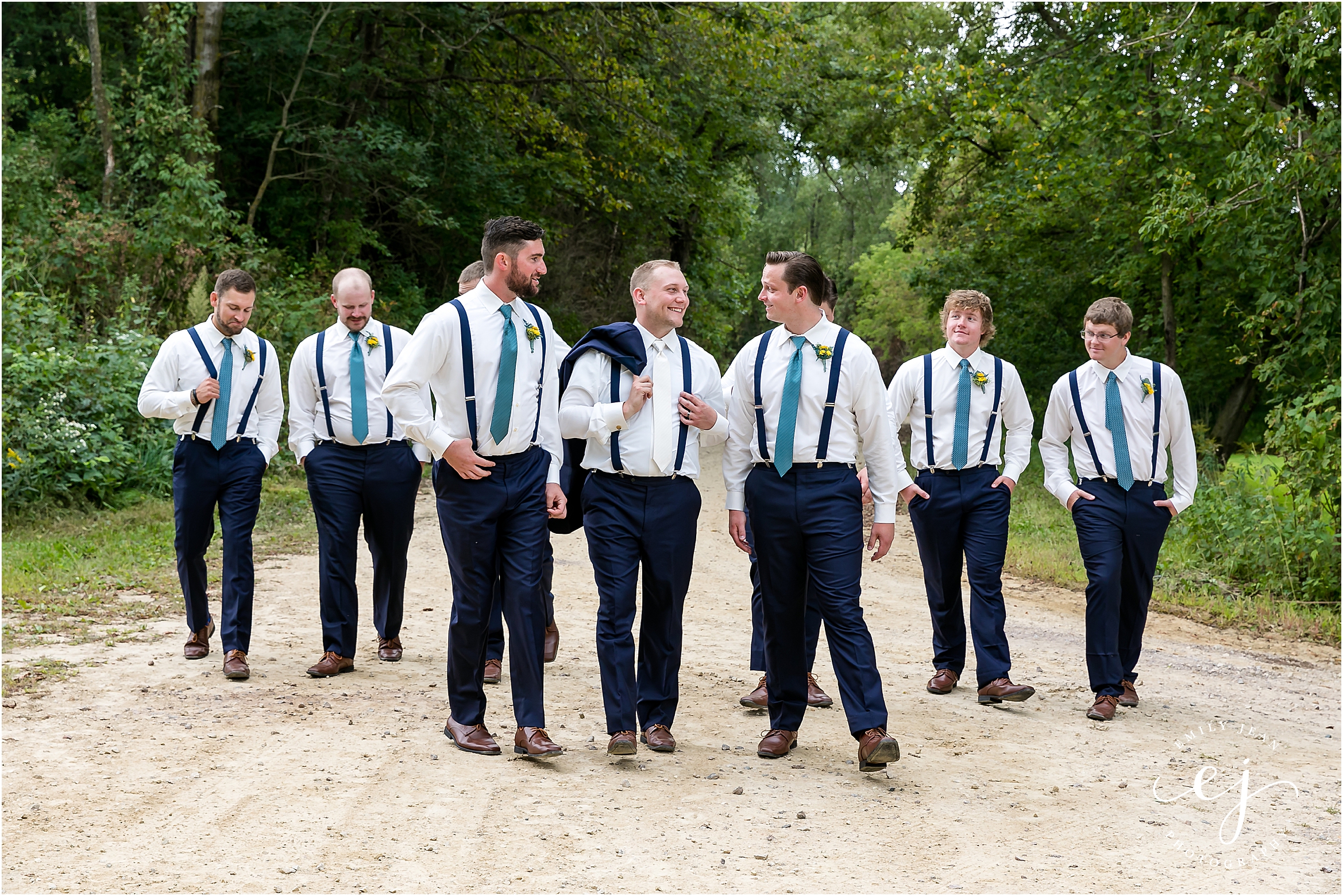groomsmen in suspenders walking and laughing blair wisconsin wedding
