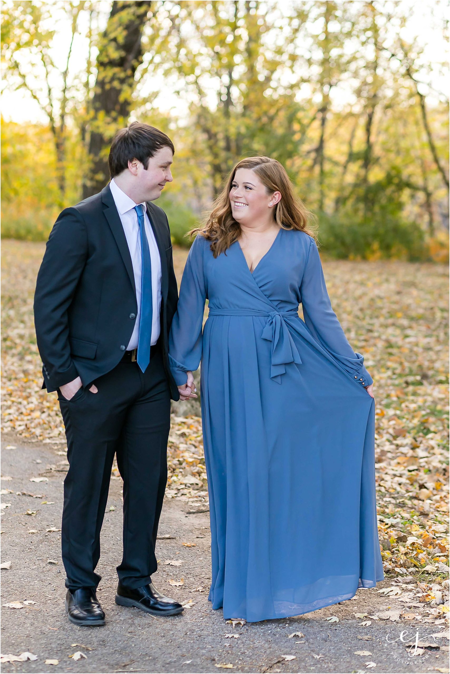engagement session suit and tie long blue dress walking in park