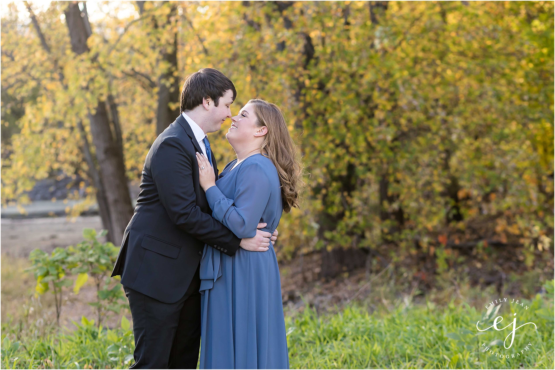 engagement session suit and tie long blue dress dancing in park