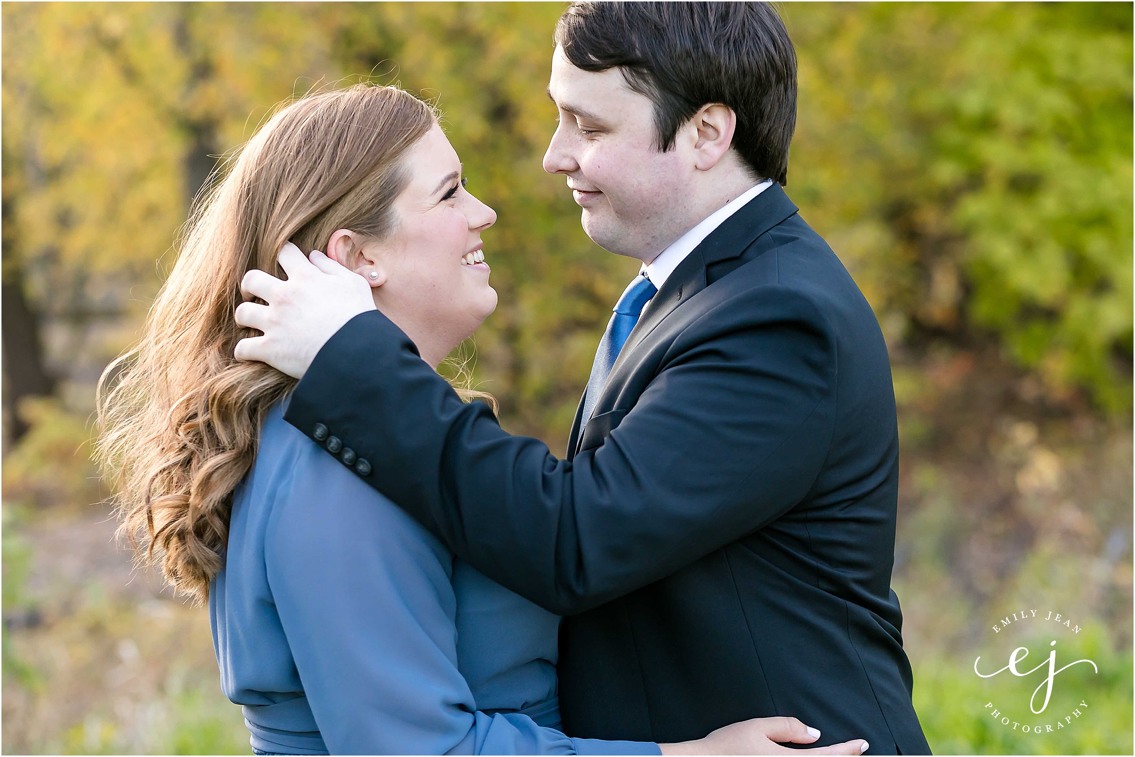baltic born blue dress engagement photo groom tucking bride's hair back
