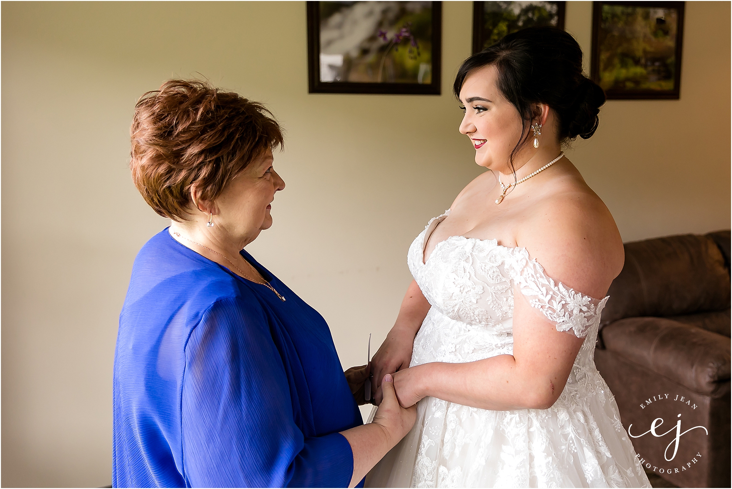 bride getting dressed mom buttoning dress at winnebago springs wedding cabin