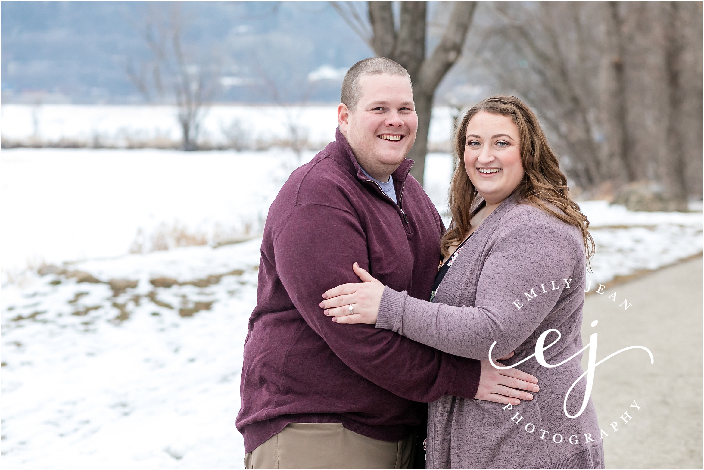 wisconsin engagement photo couple wearing mauve standing by frozen water