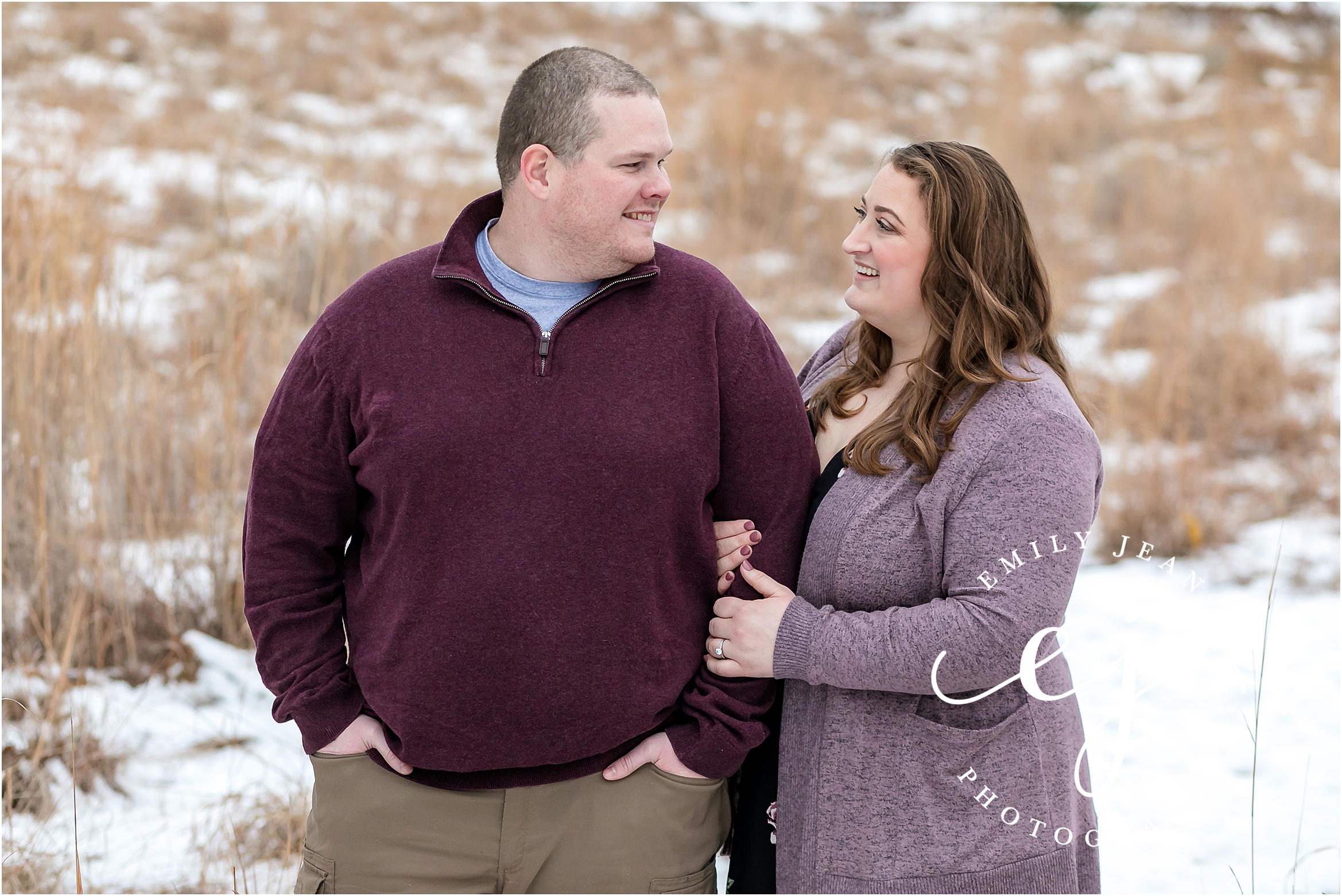 couple standing in snow engagement session wisconsin plus size couple