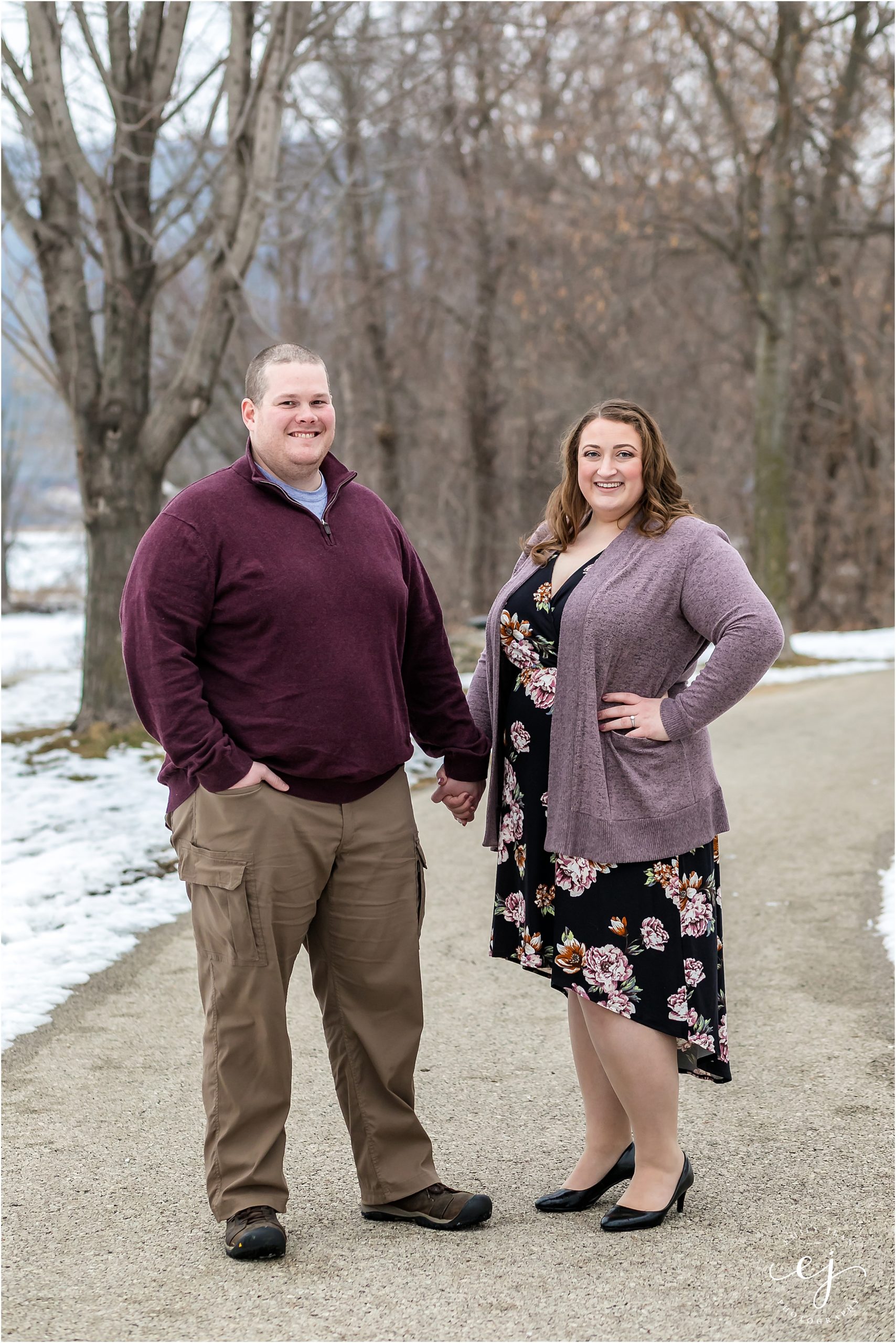 winter engagement session wisconsin man and woman standing on path wearing purple