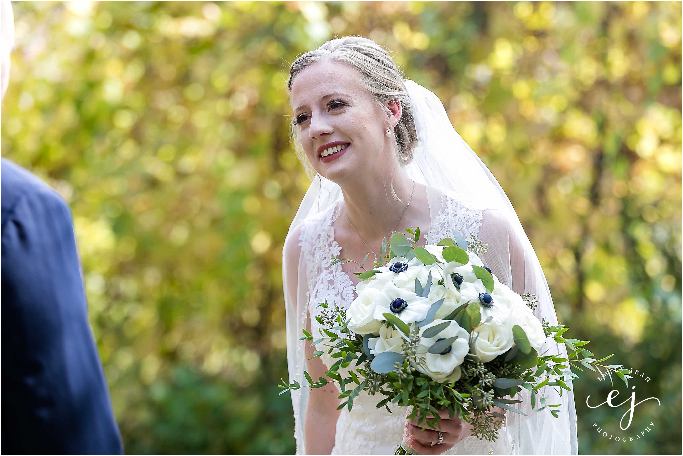 bride smiling and crying at first look 