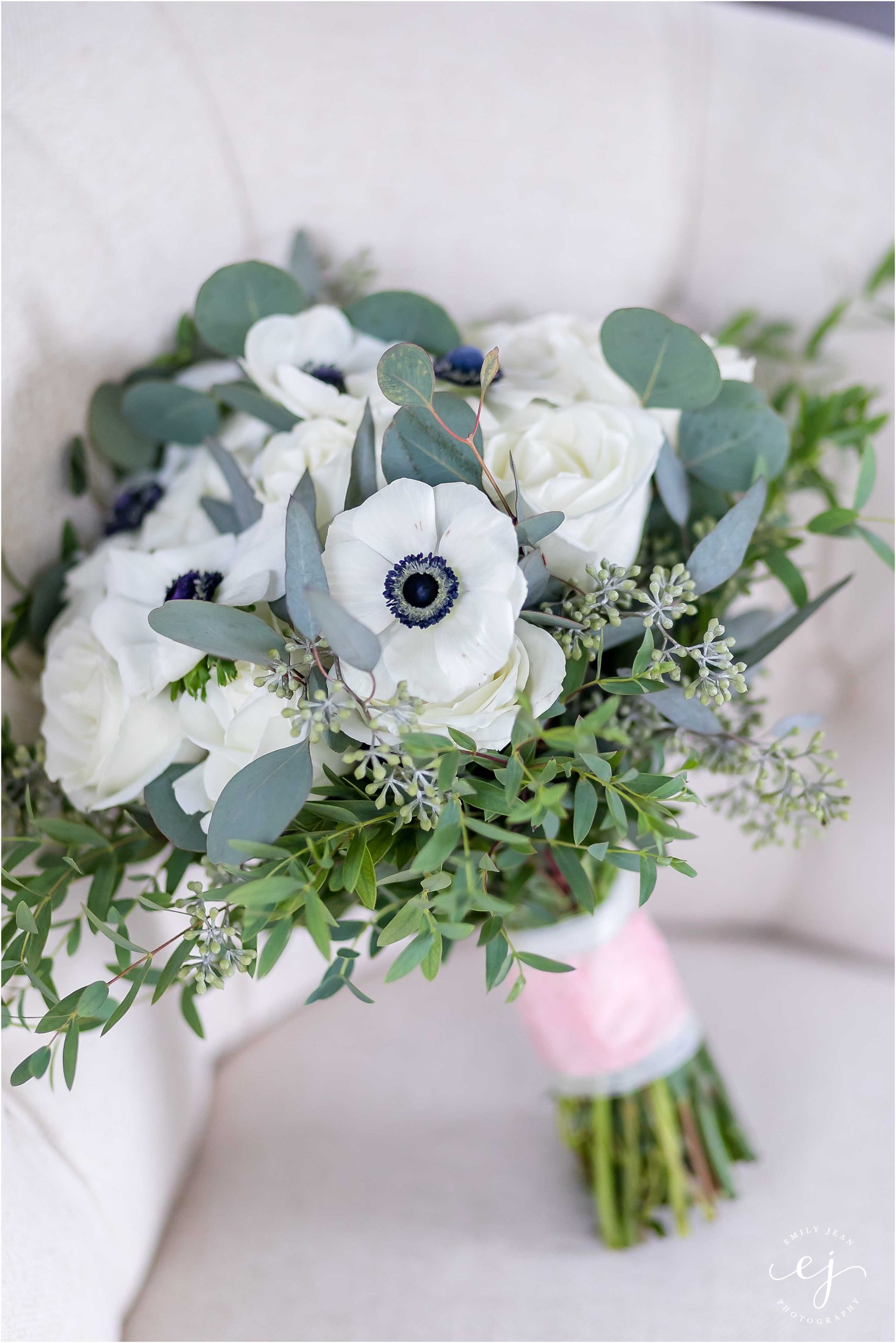 White bouquet with navy centers greenery loose
