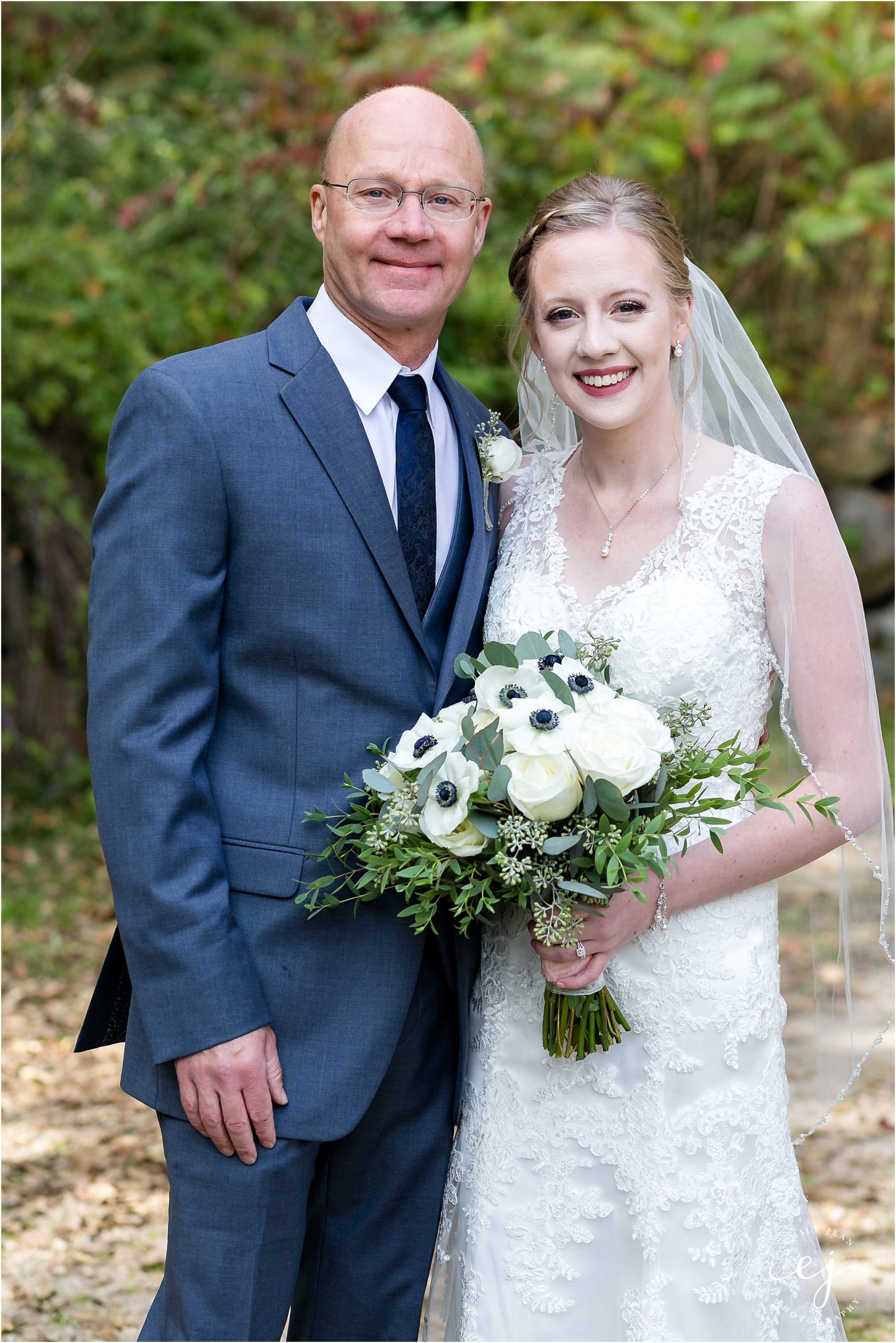 Portrait of bride with her dad at her wedding gray suit navy tie