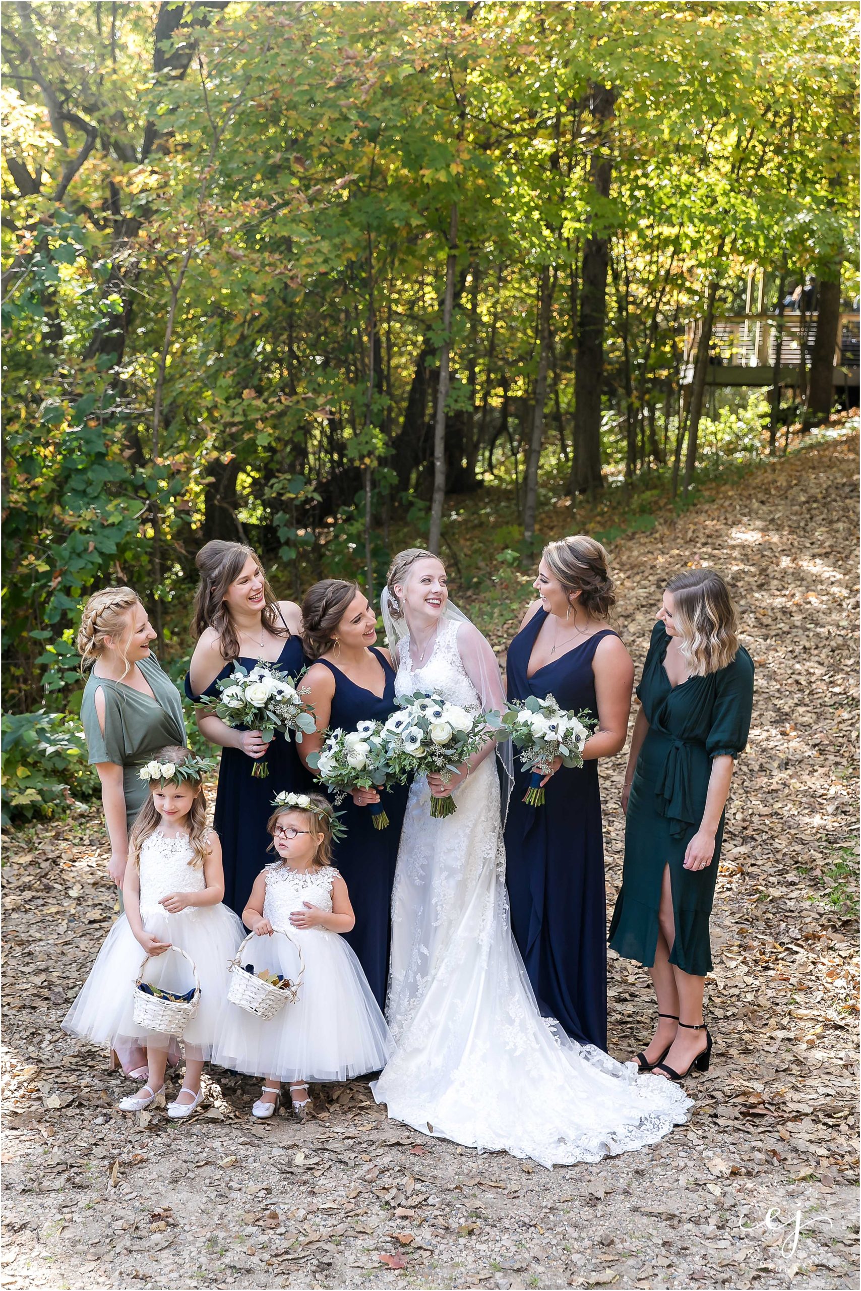 Bridesmaids bride and personal attendance flower girls navy and emerald outside at Edgewood farm wedding