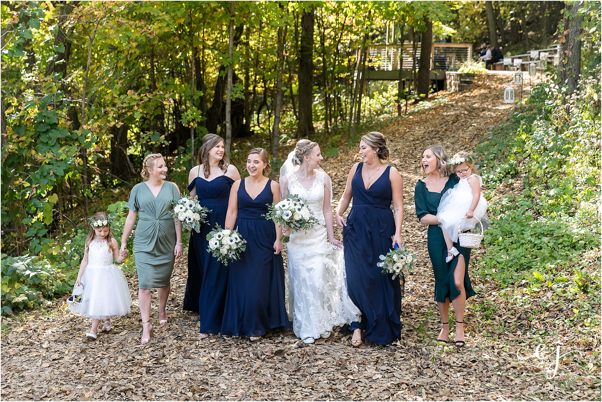Bridesmaids bride and personal attendance flower girls navy and emerald outside at Edgewood farm wedding