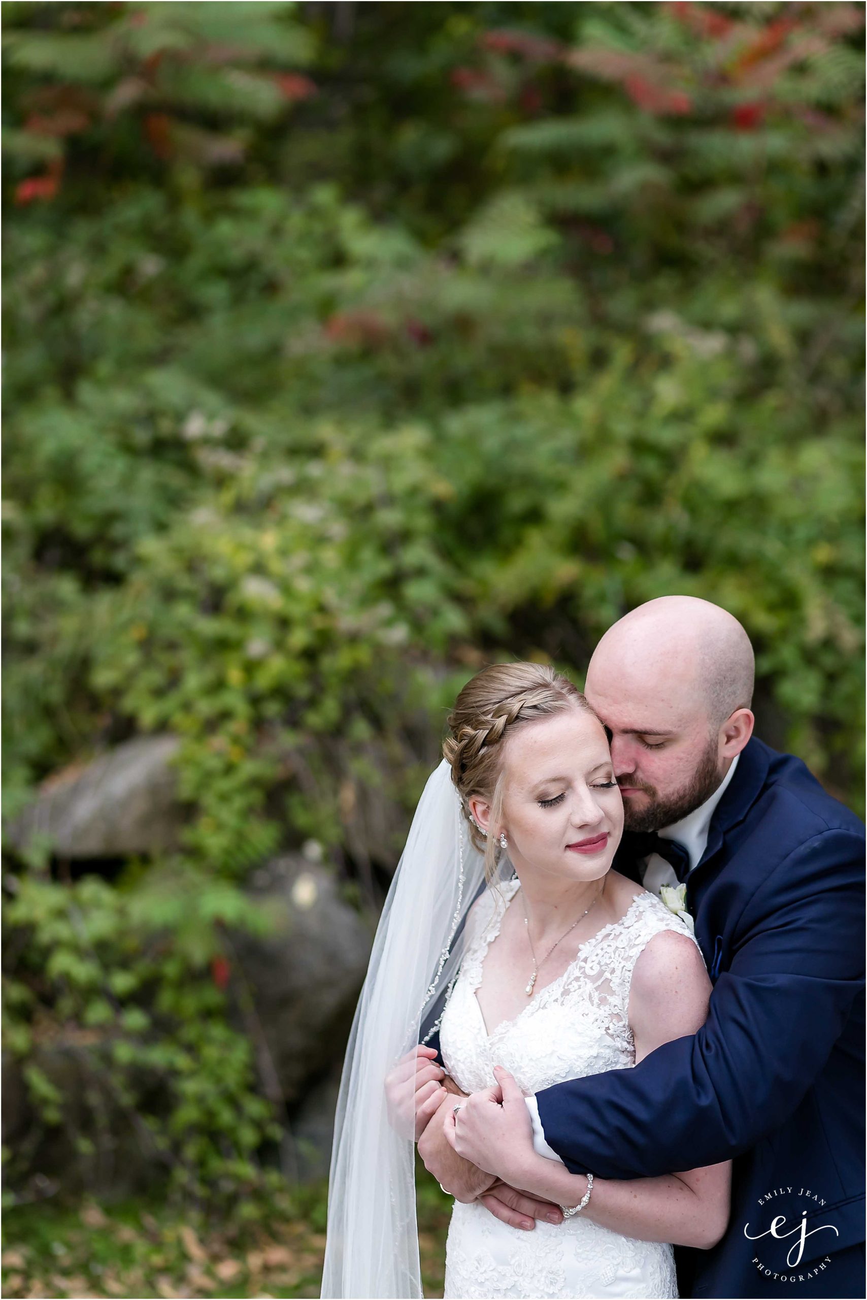 Romantic photo outside in the fall groom holding bride kissing her cheek Minnesota wedding