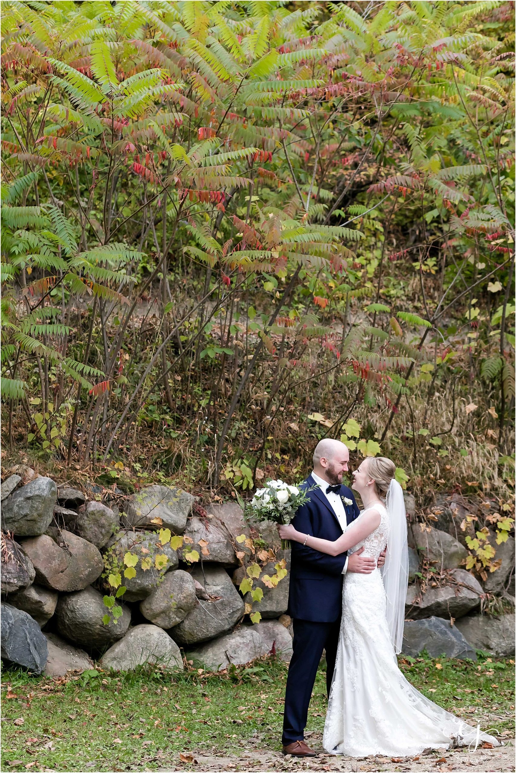 Bride and groom among autumn scenery at Edgewood farm in Minnesota