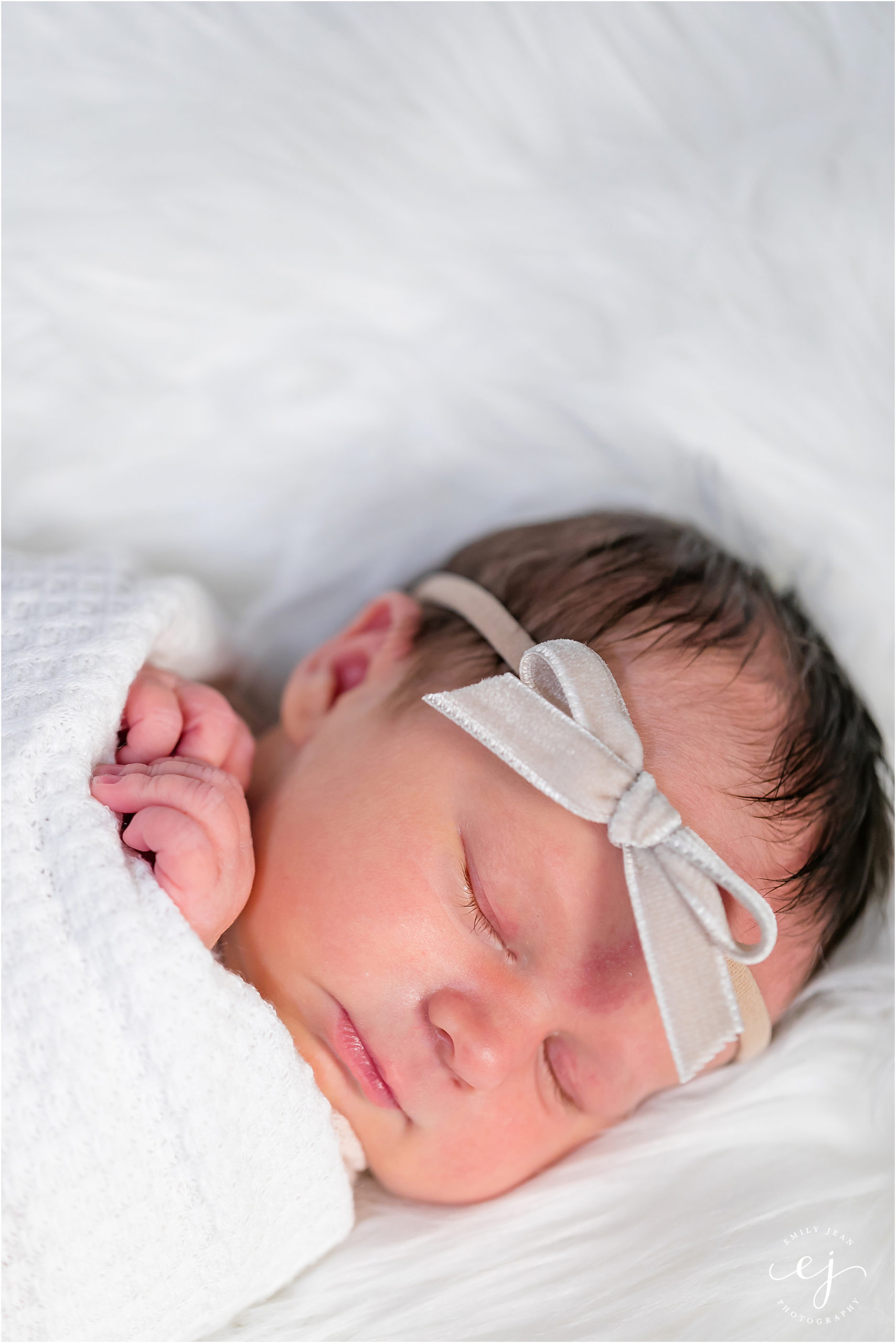 little baby newborn girl with neutral velvet bow