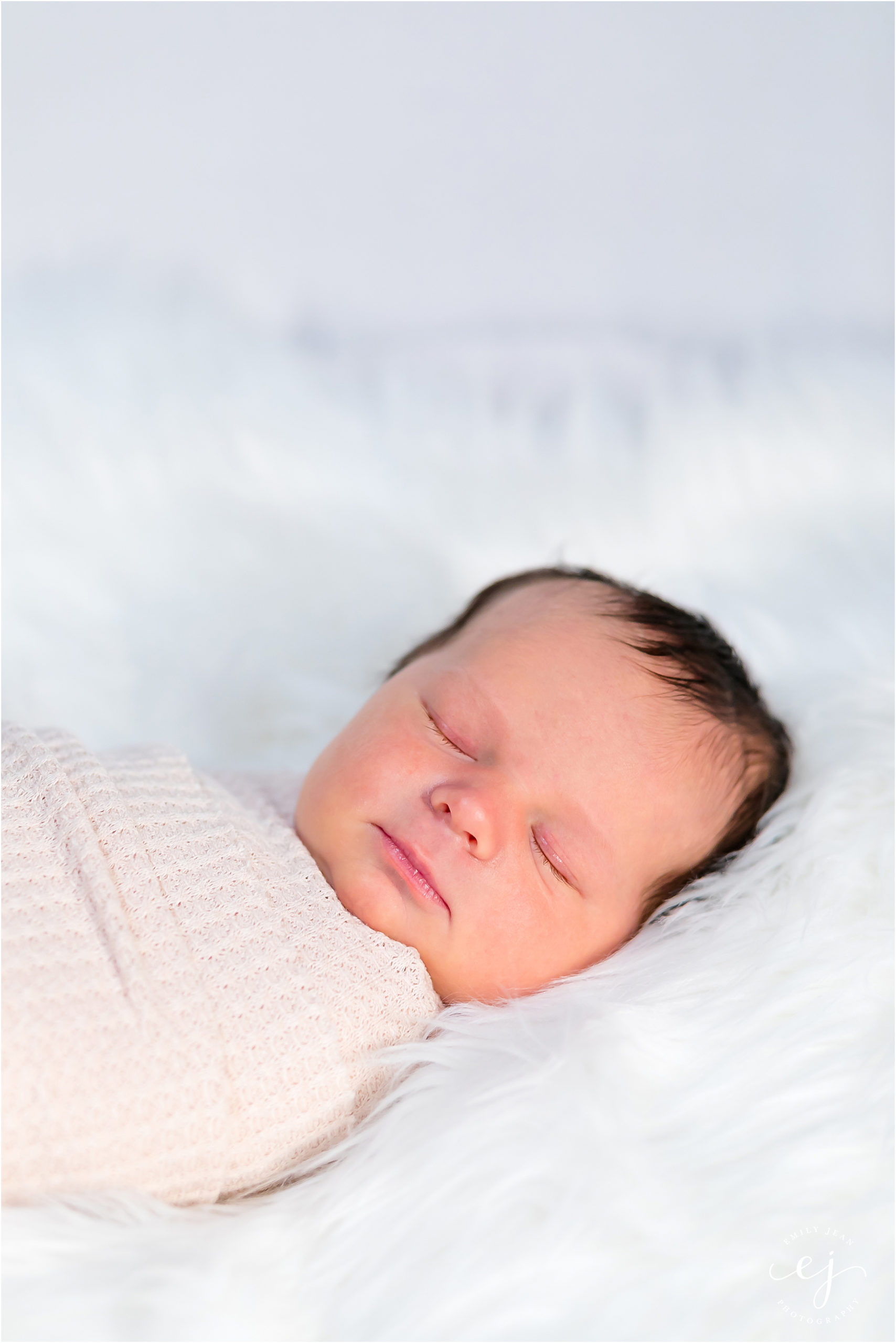 sweet little baby newborn photo laying on fur