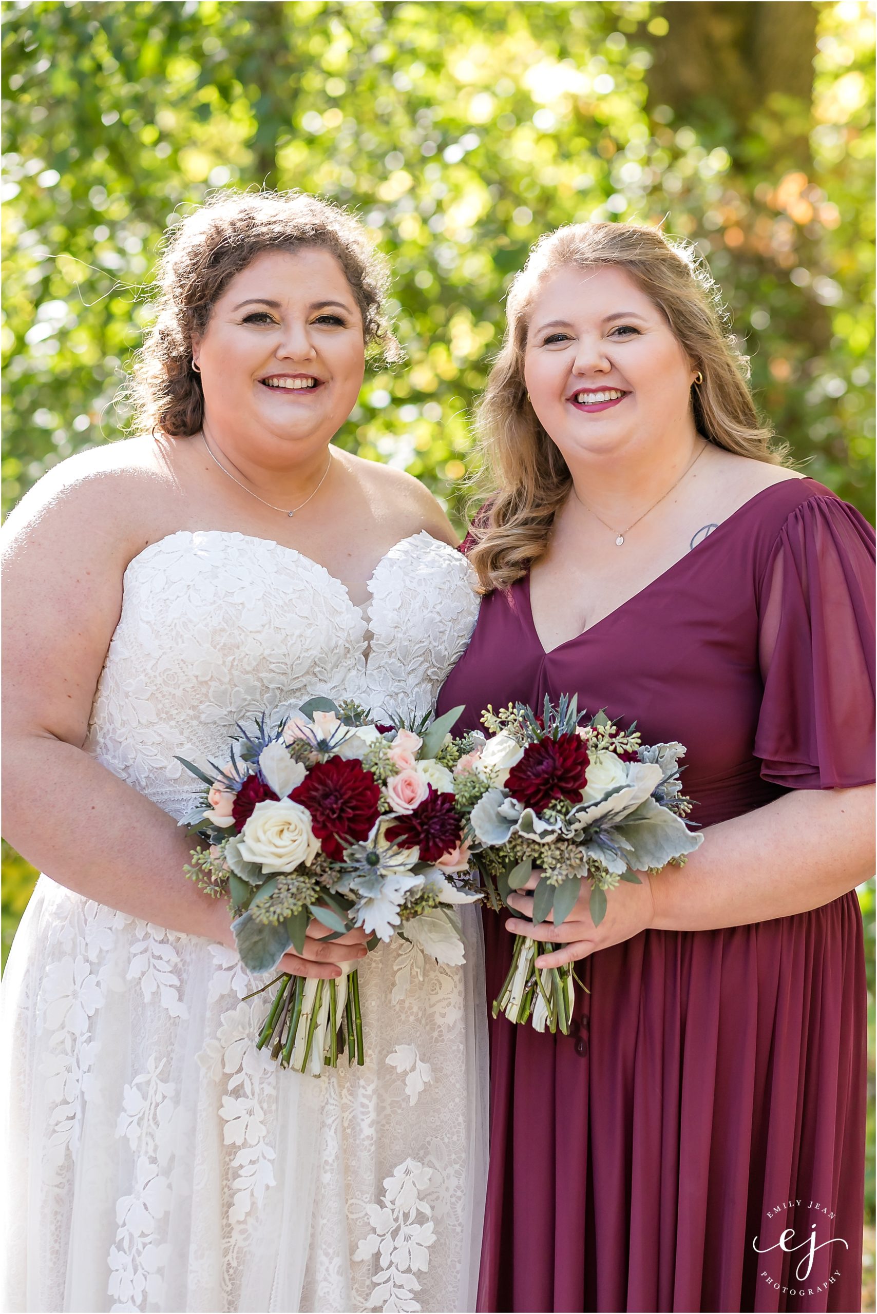 bride and her sister maid of honor with burgundy and pink bouquets