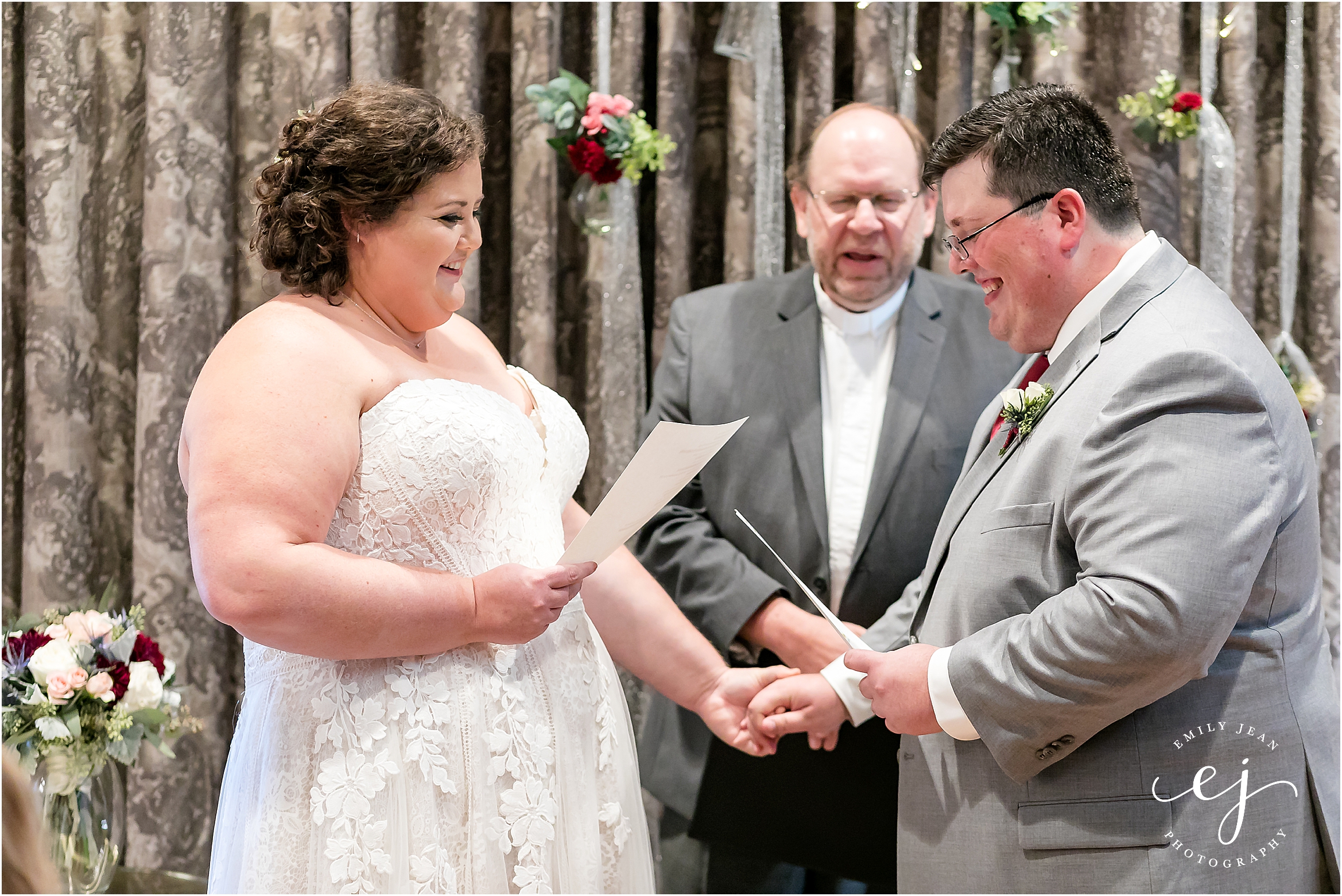 reading vows to each other while holding hand at the charmat hotel in lacrosse wisconsin