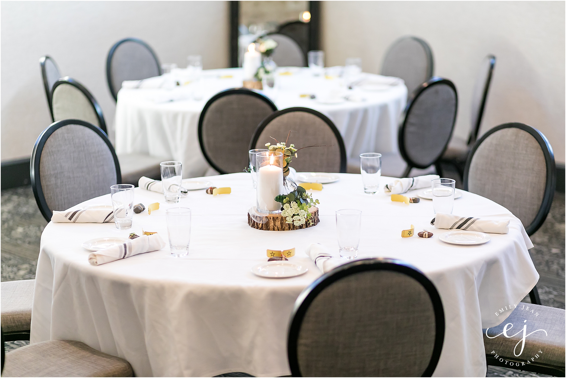 white linen round table wedding with grey covered chairs