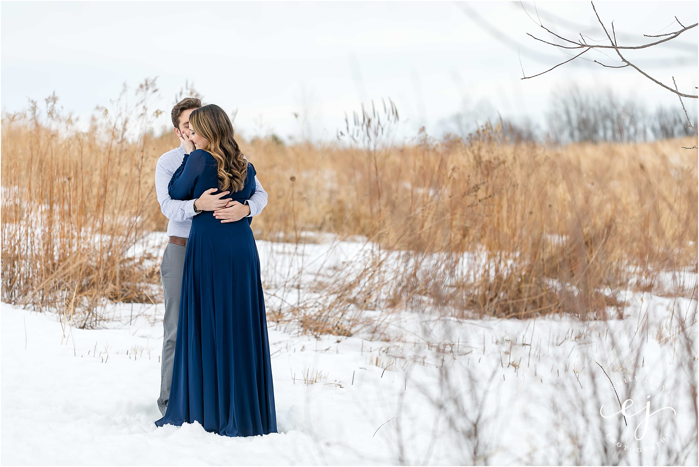 engagement session winter couple standing in snowy field la crosse