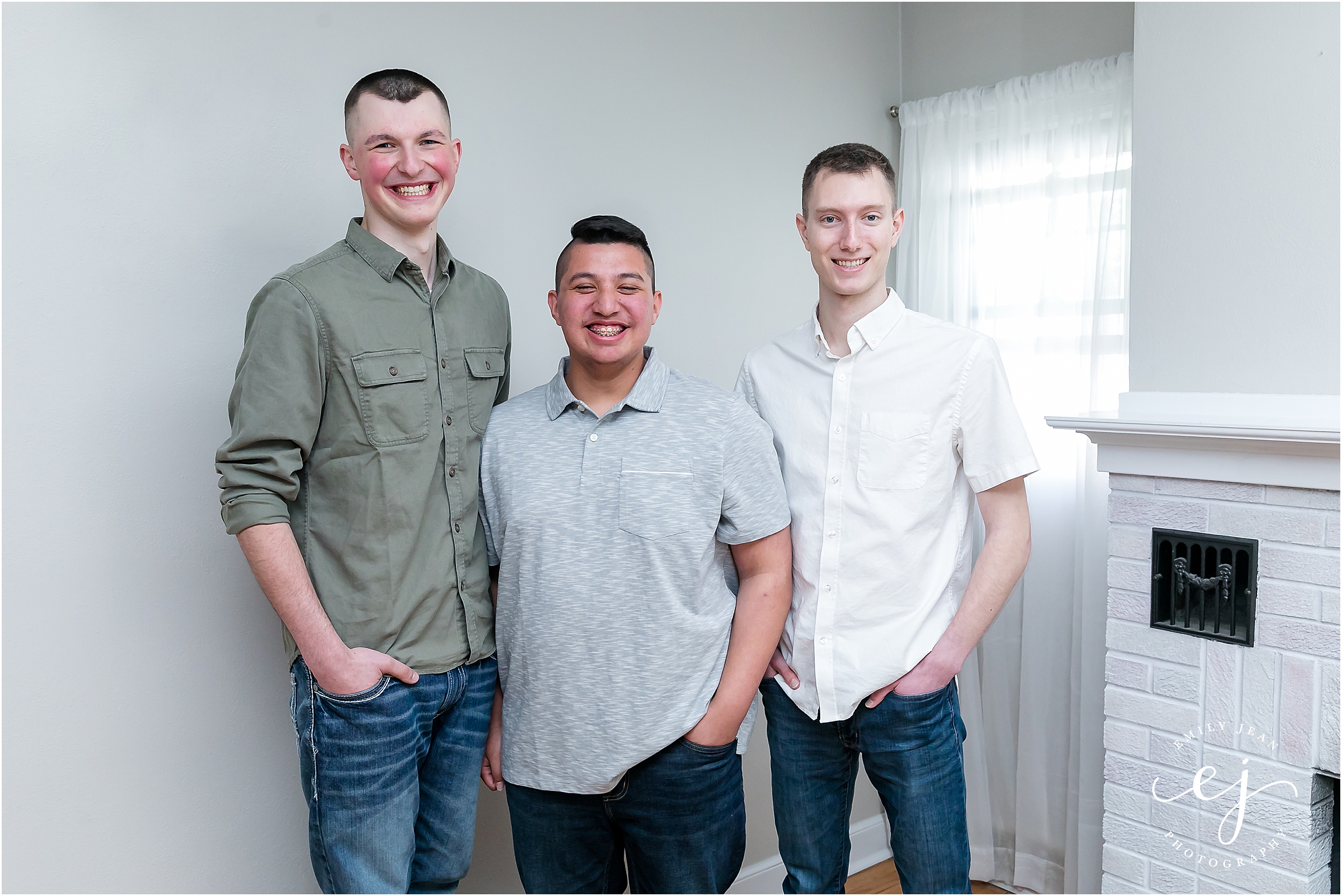 Three adult children brothers standing and smiling at the camera