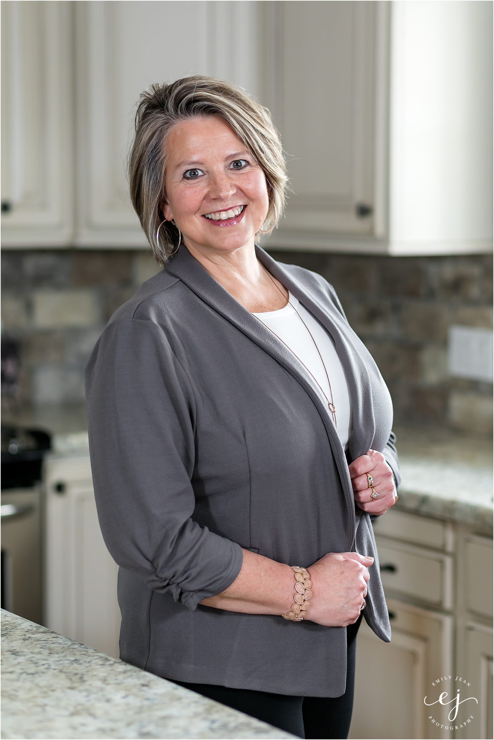 Real estate agent professional headshot one trust La Crosse Wisconsin woman standing in kitchen