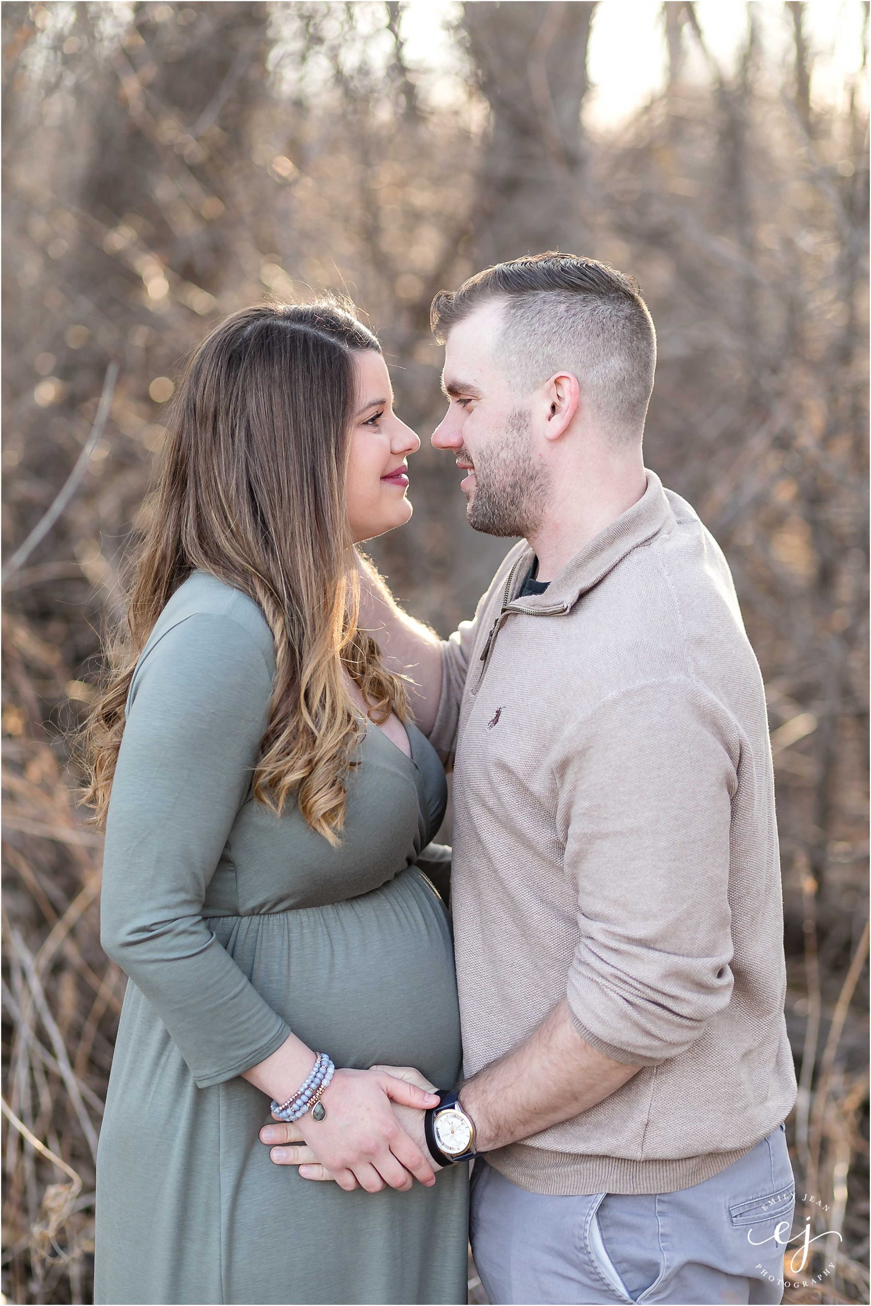 husband and wife wearing neutral colors maternity photo