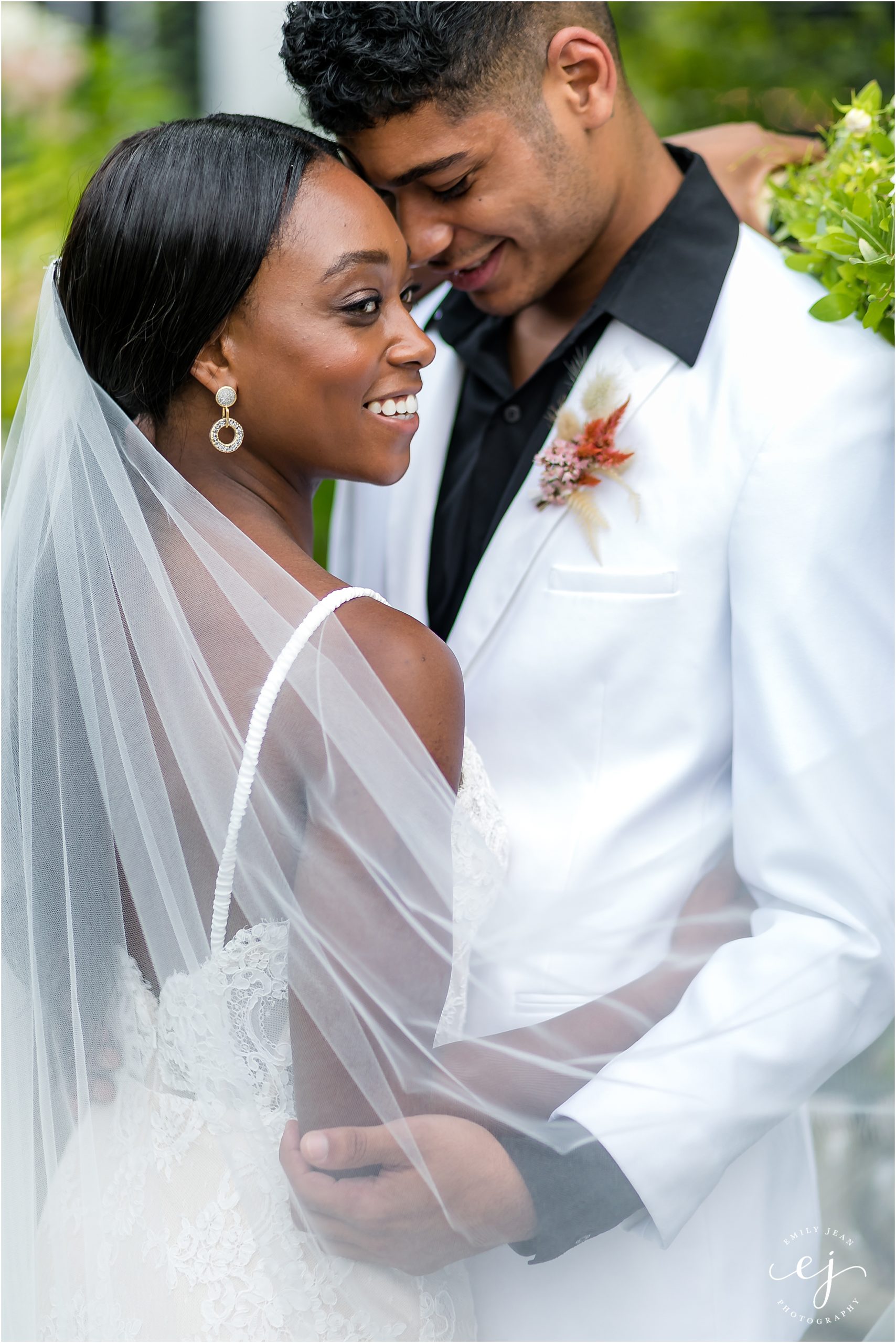 black bride and groom smiling and stunggling