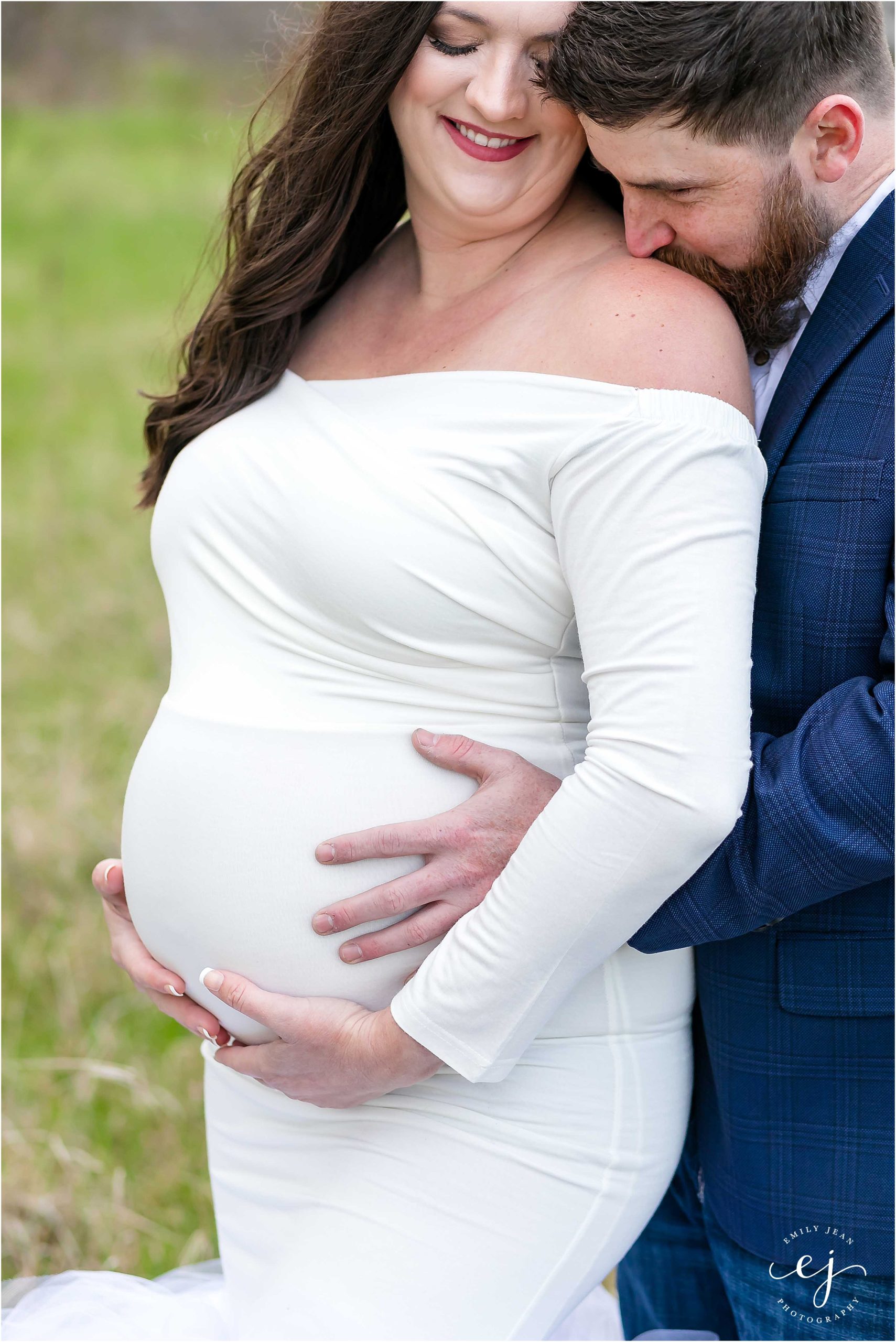 Maternity photo man hugging wife kissing her neck