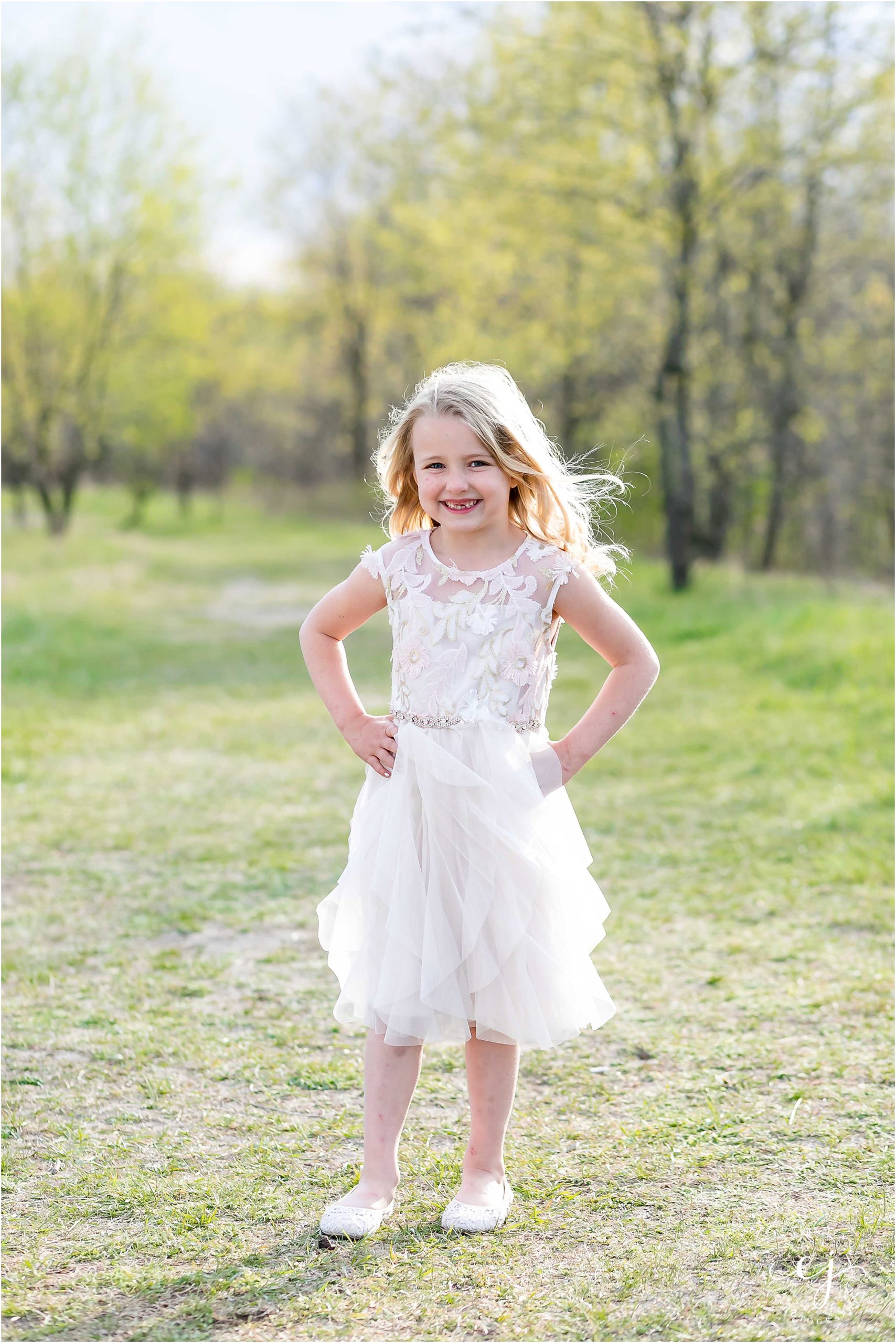 Six year old professional photos wearing beautiful dress at a park