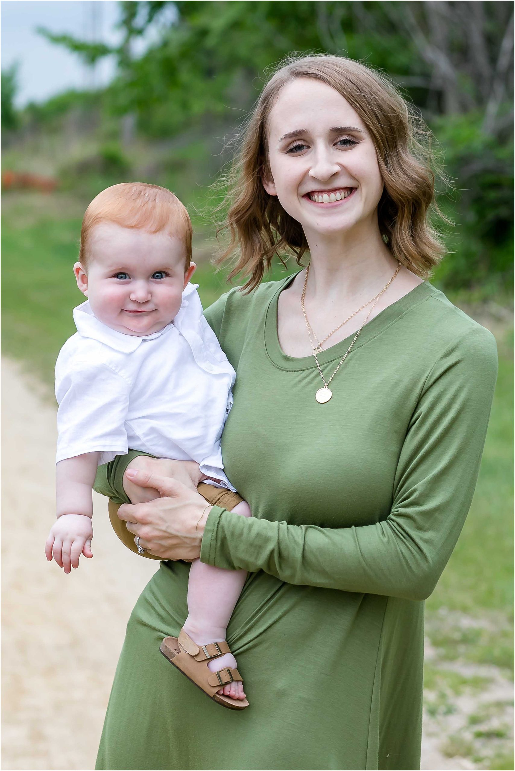 mom holding redhead baby smiling onalaska wisconsin