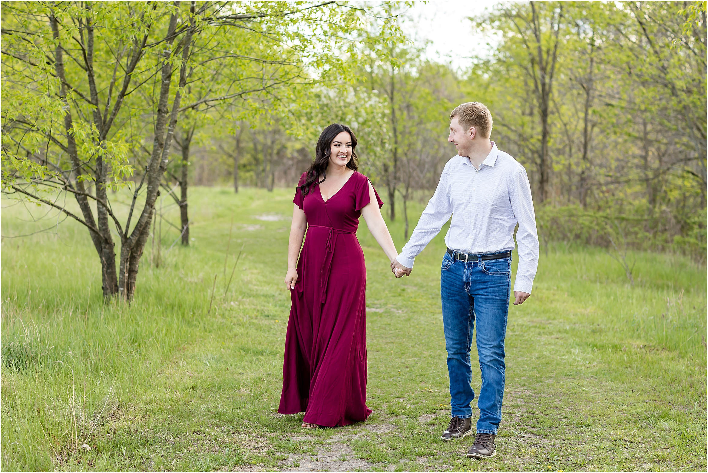 girl and guy walking in park during engagement session