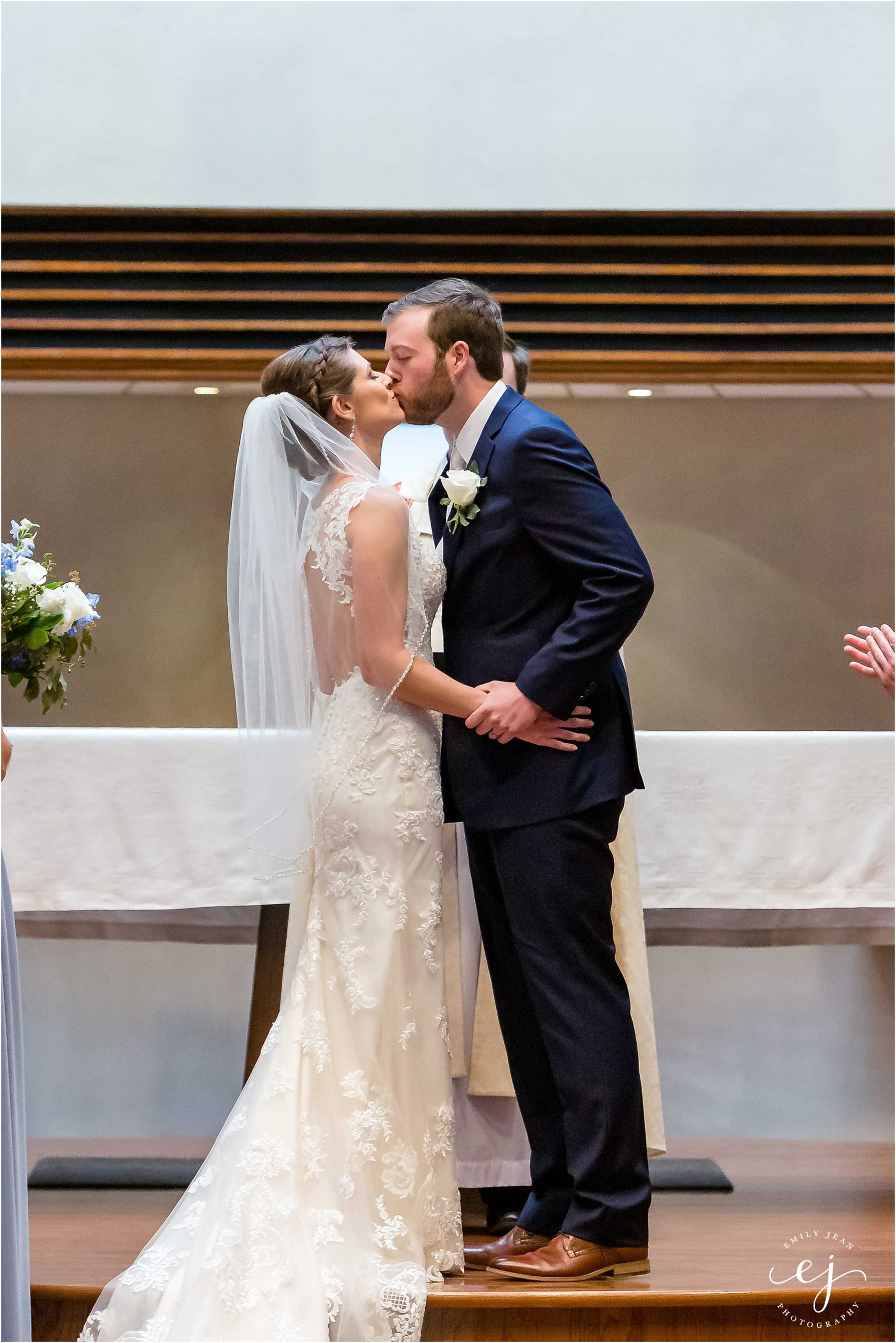 kissing at newman center wedding la crosse wisconsin