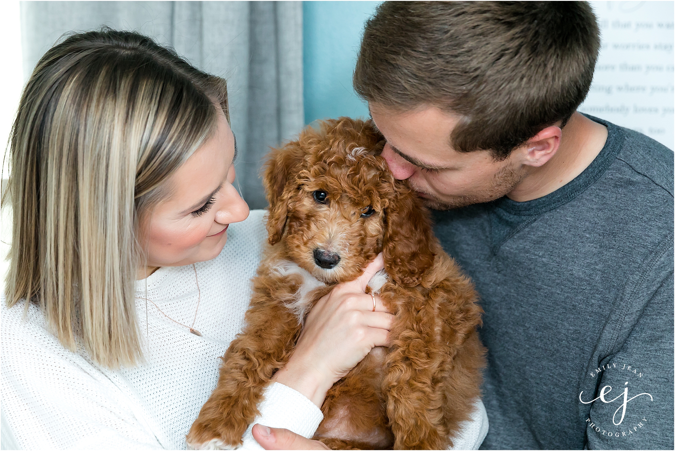 young couple snuggling new golden doodle puppy la crosse wisconsin