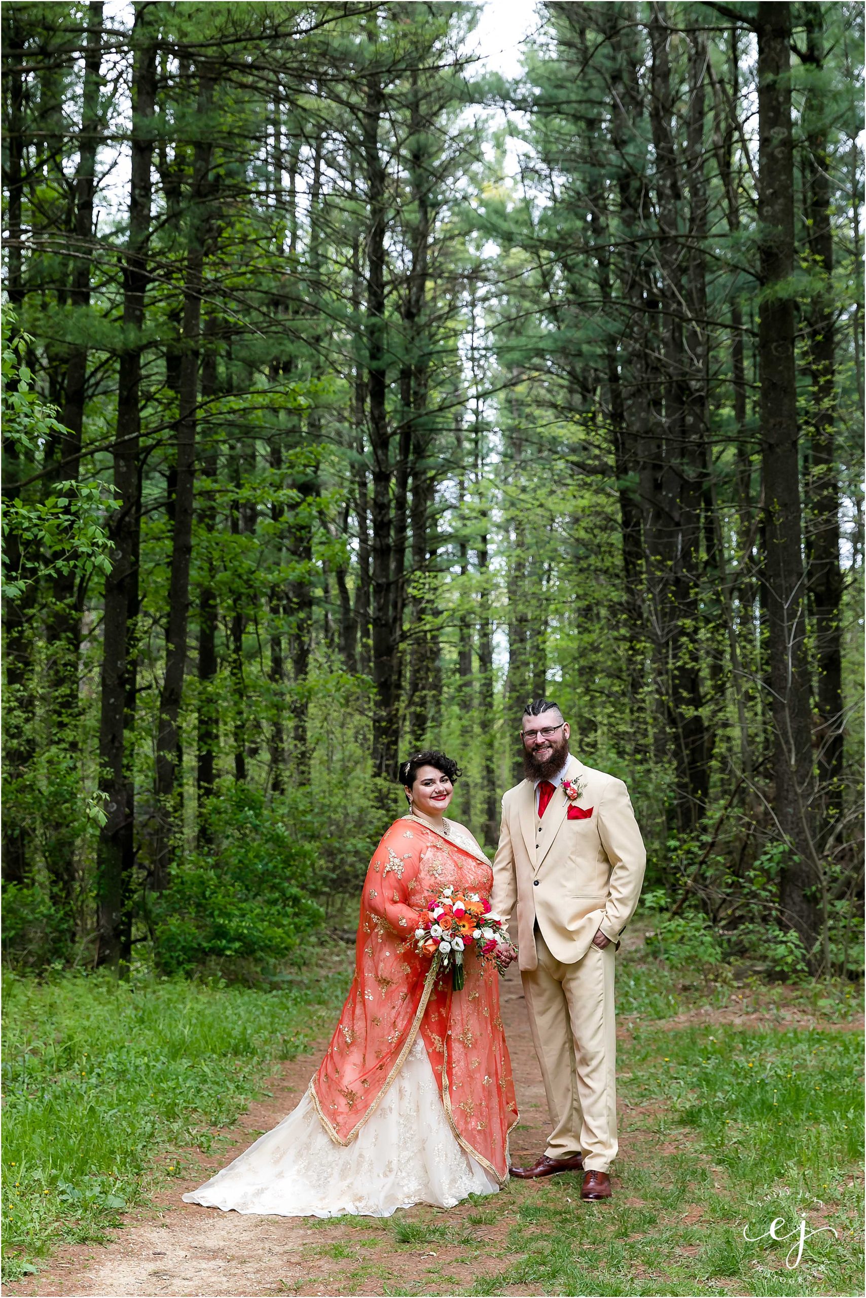 indian bride and groom standing in forest