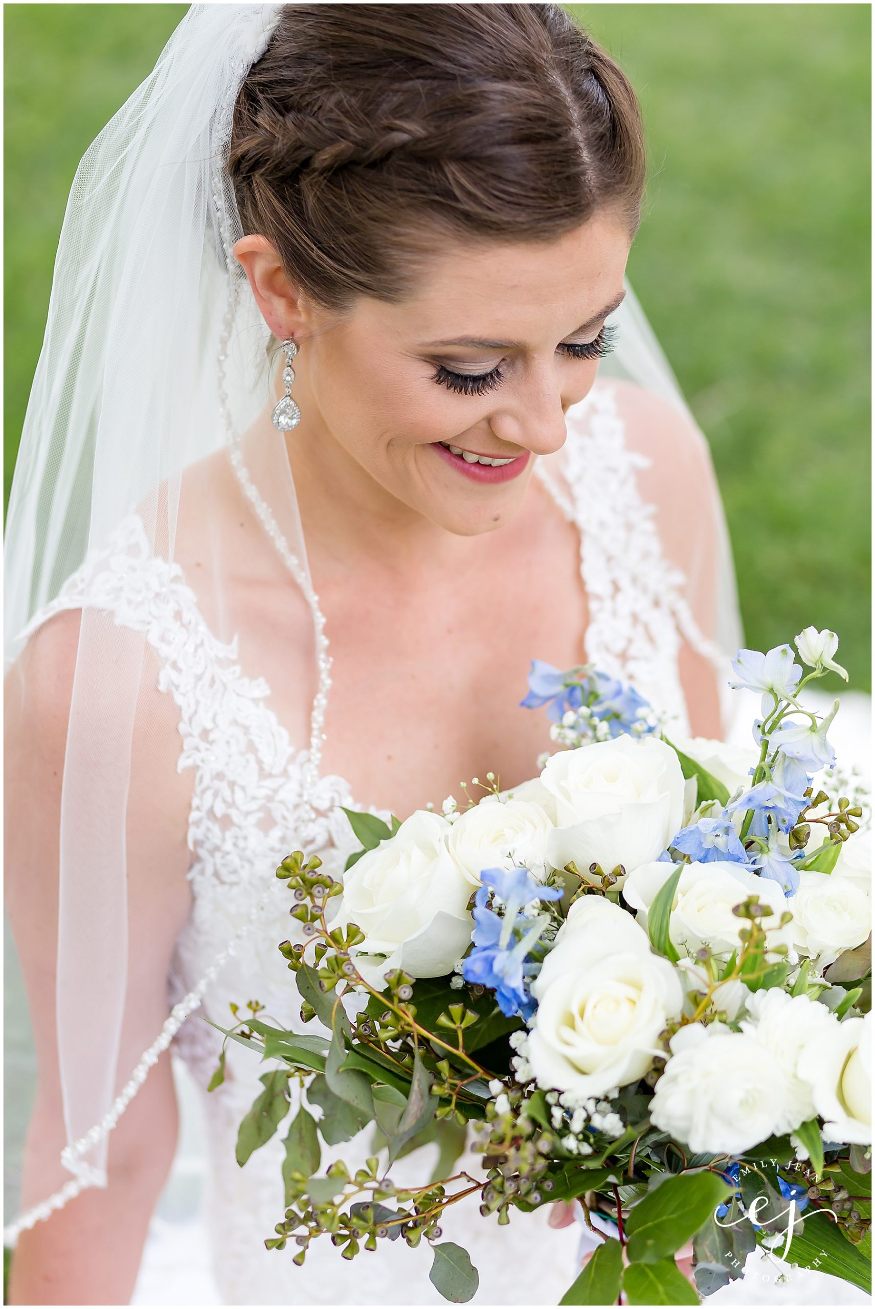 bride looking down at flowers 