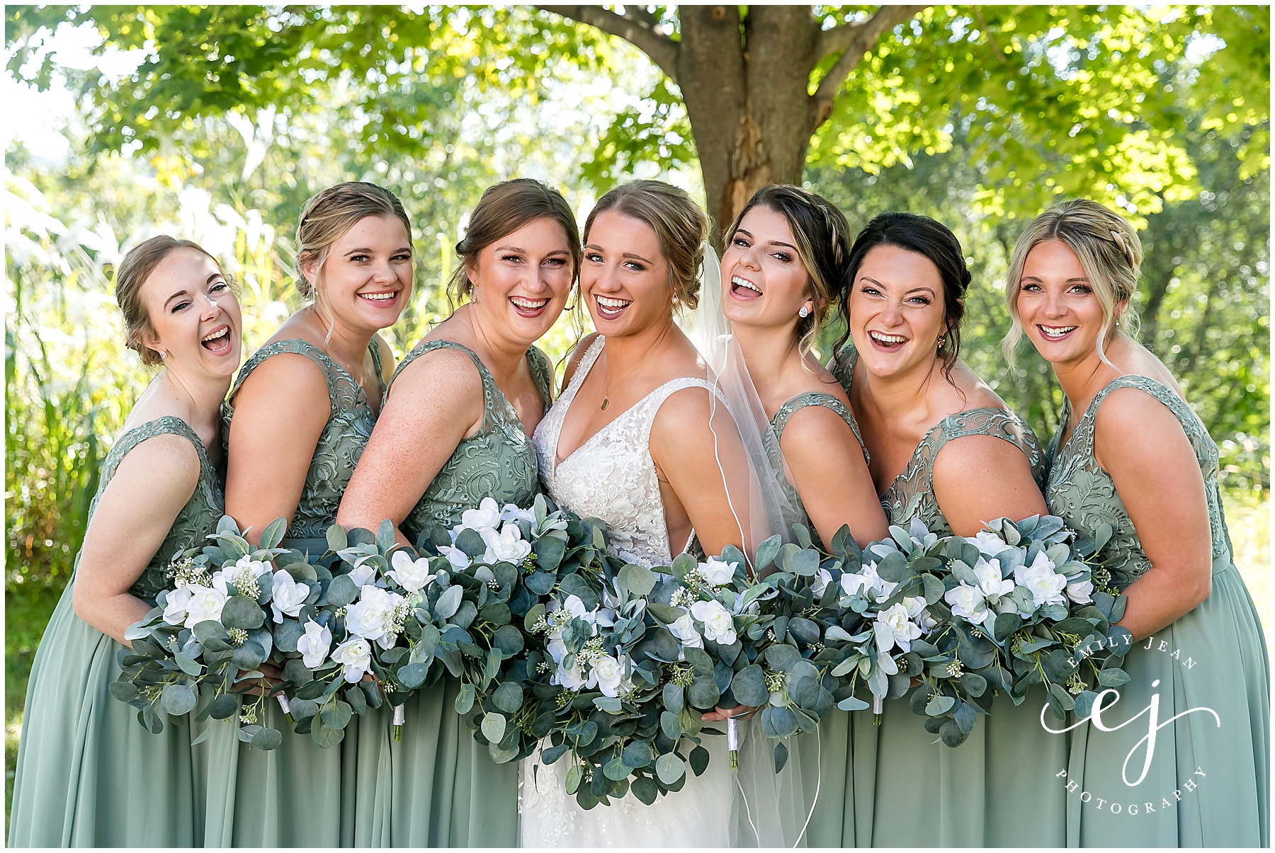 sage green and white bridesmaid dresses standing outside summer wedding at stoney creek hotel