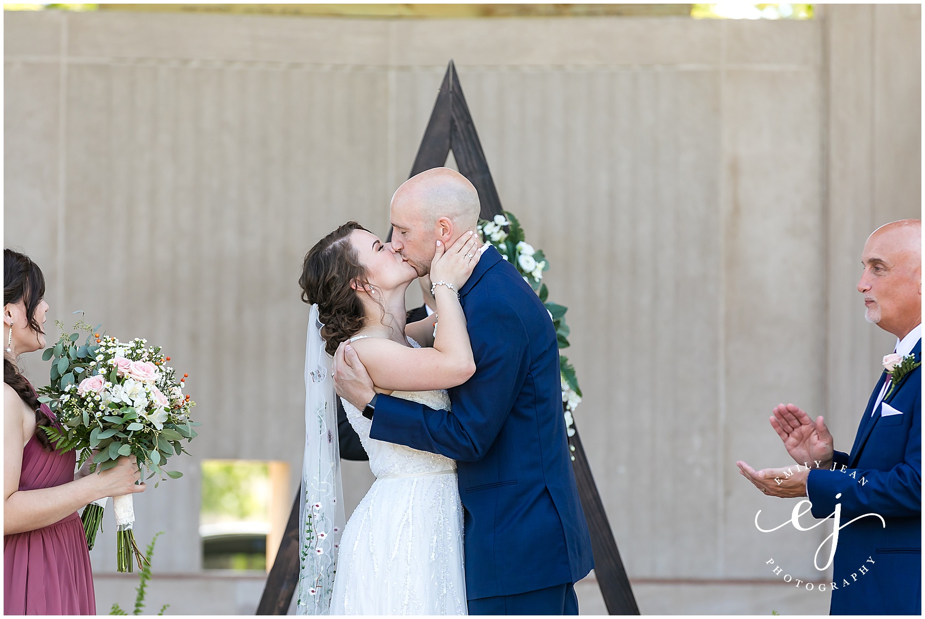 first kiss bride and groom riverside bandshell