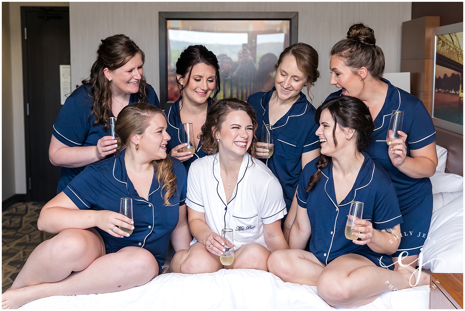bride and bridesmaids in pajamas on bed